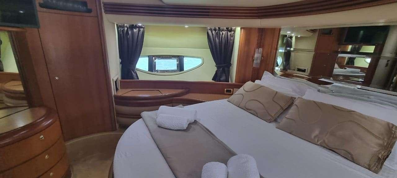 a room with a bed and a window aboard SEA LA VIE Yacht for Charter