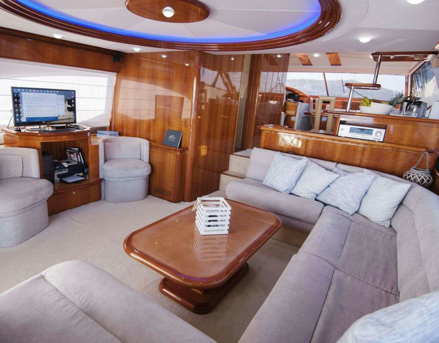 a living room with a couch and a television aboard SERENE Yacht for Charter