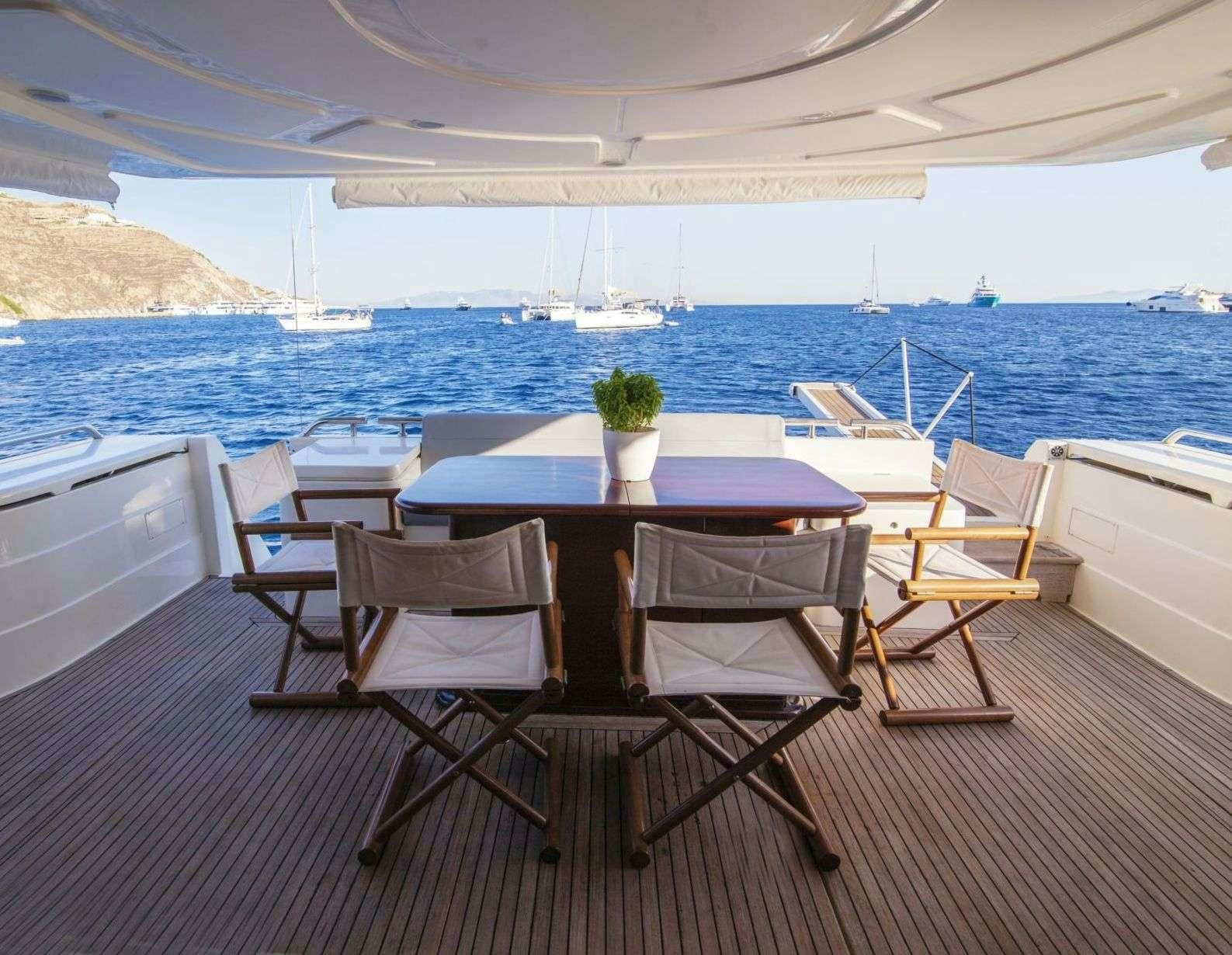 a table and chairs on a patio aboard SERENE Yacht for Charter