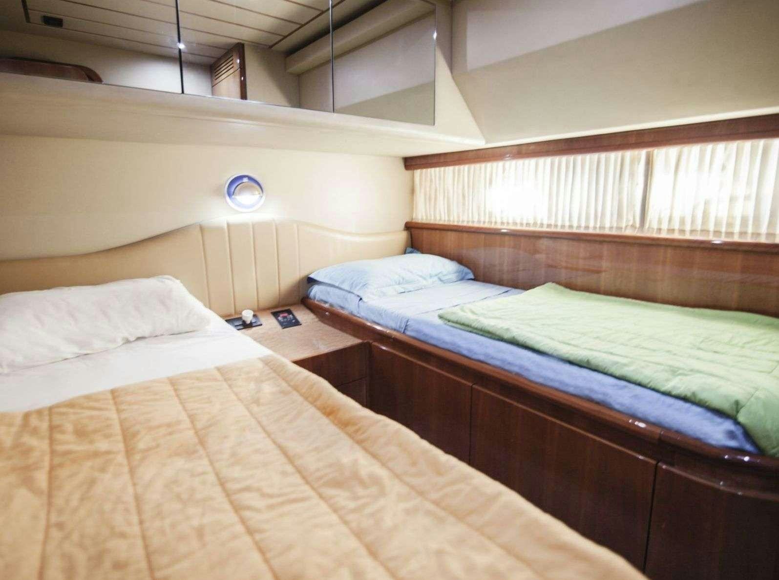 a couple of beds in a room aboard SERENE Yacht for Charter