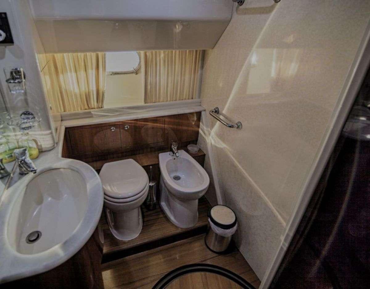 a bathroom with a toilet and sink aboard SERENE Yacht for Charter