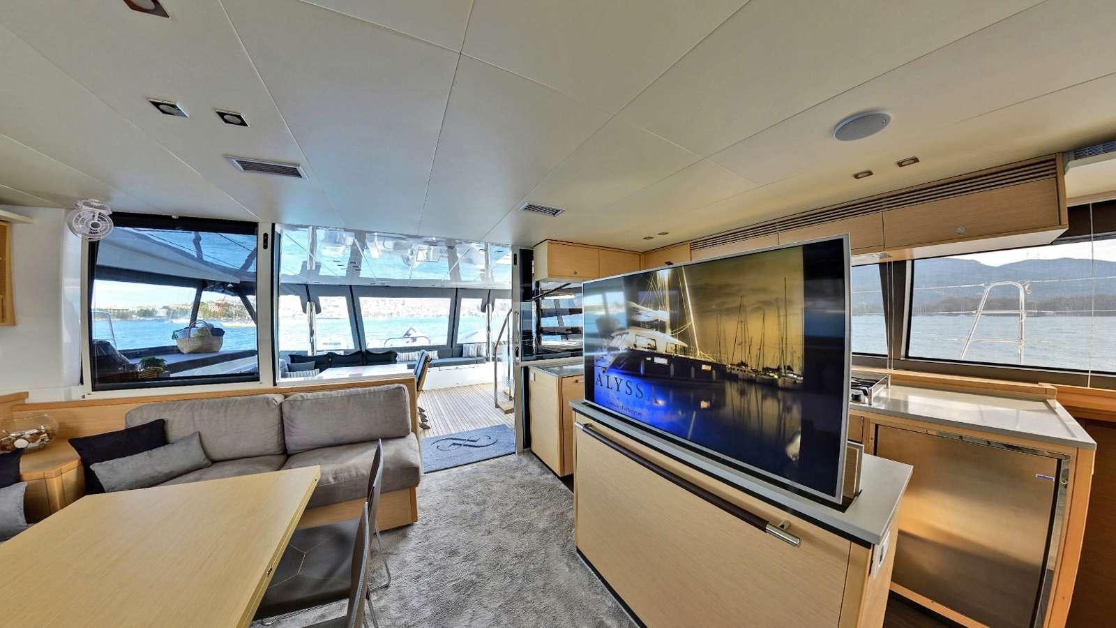 a living room with a large television aboard Alyssa Yacht for Charter