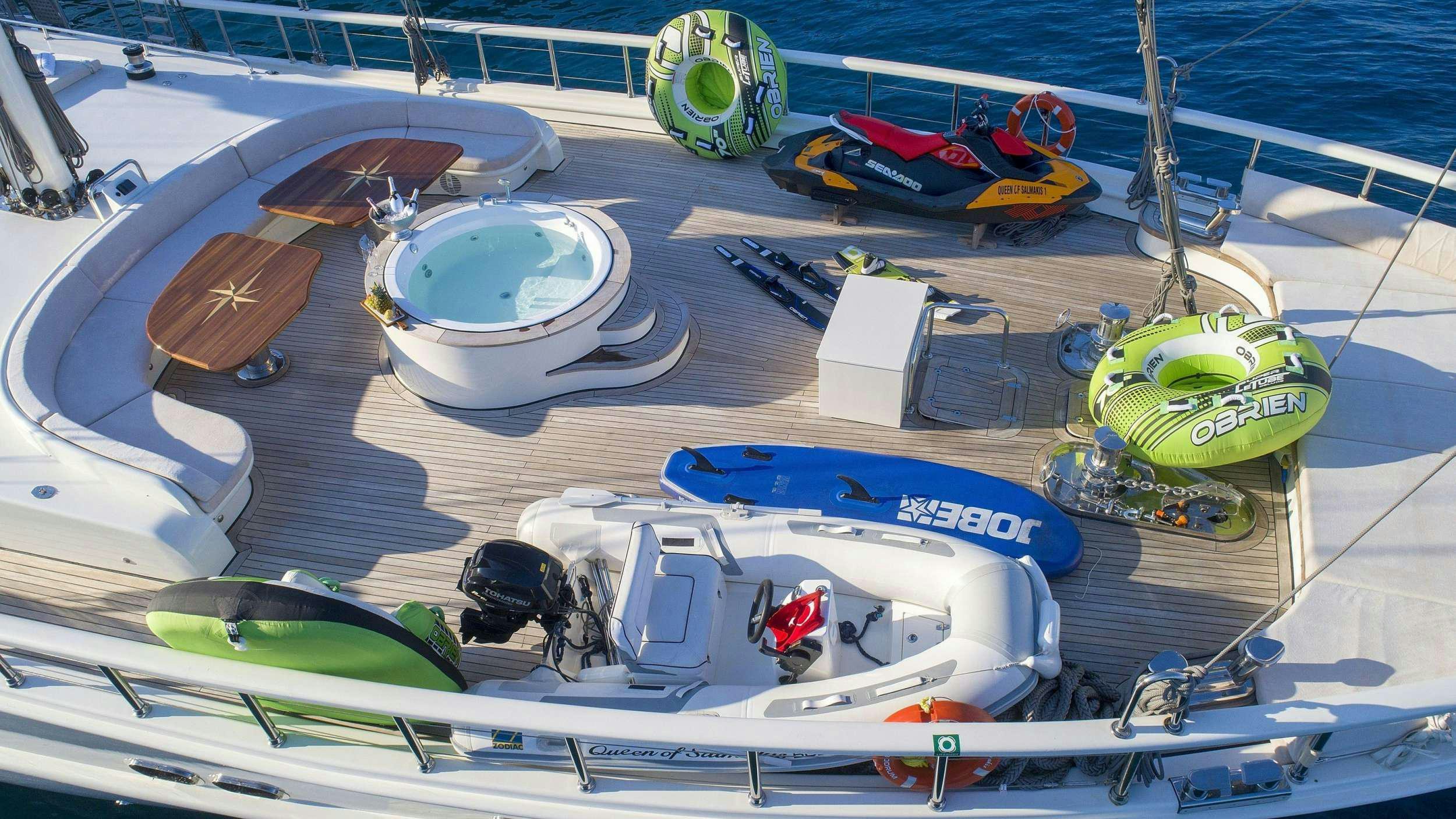 a boat with a green and white propeller on it aboard QUEEN OF SALMAKIS Yacht for Charter