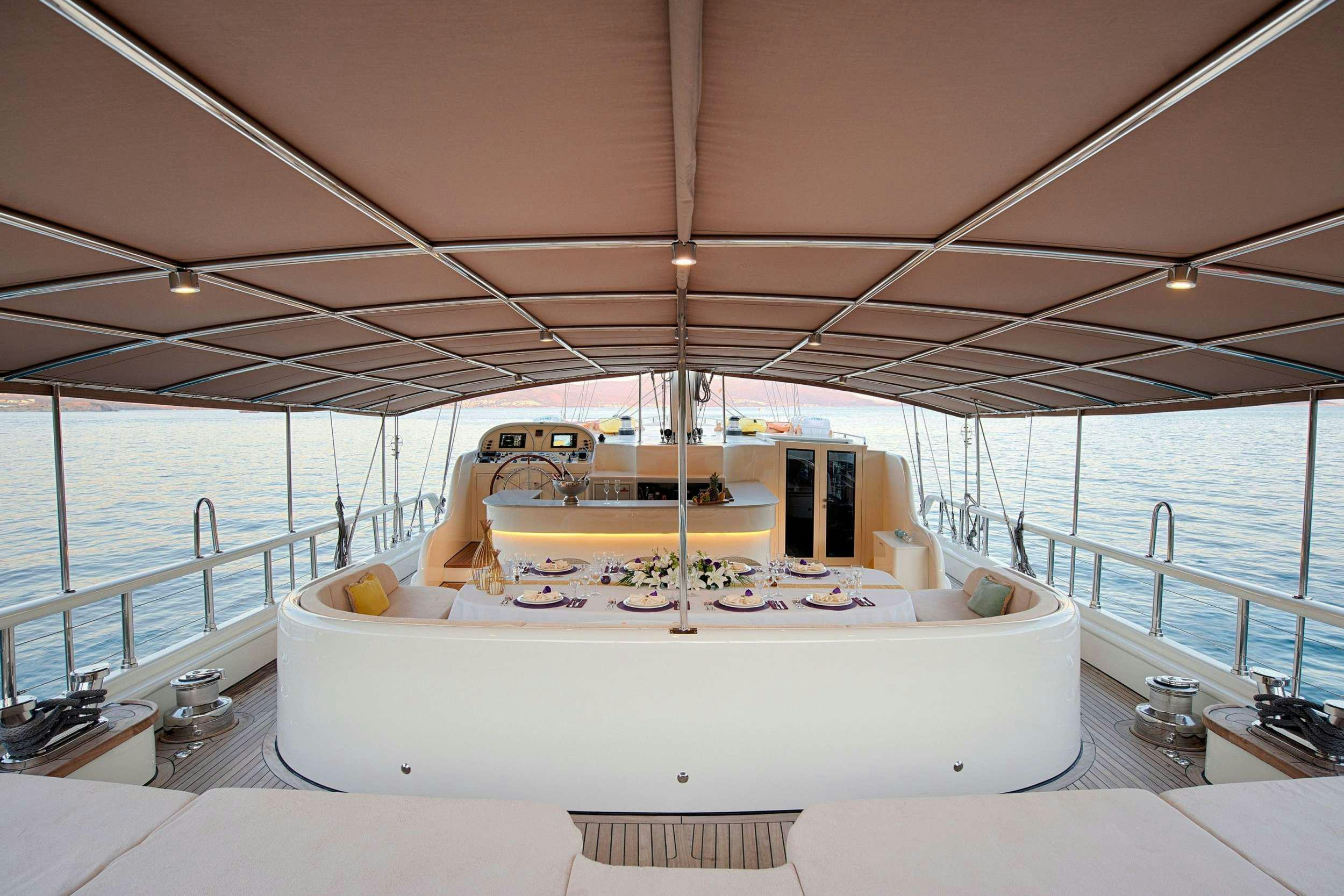 a large white bed on a boat aboard QUEEN OF SALMAKIS Yacht for Charter