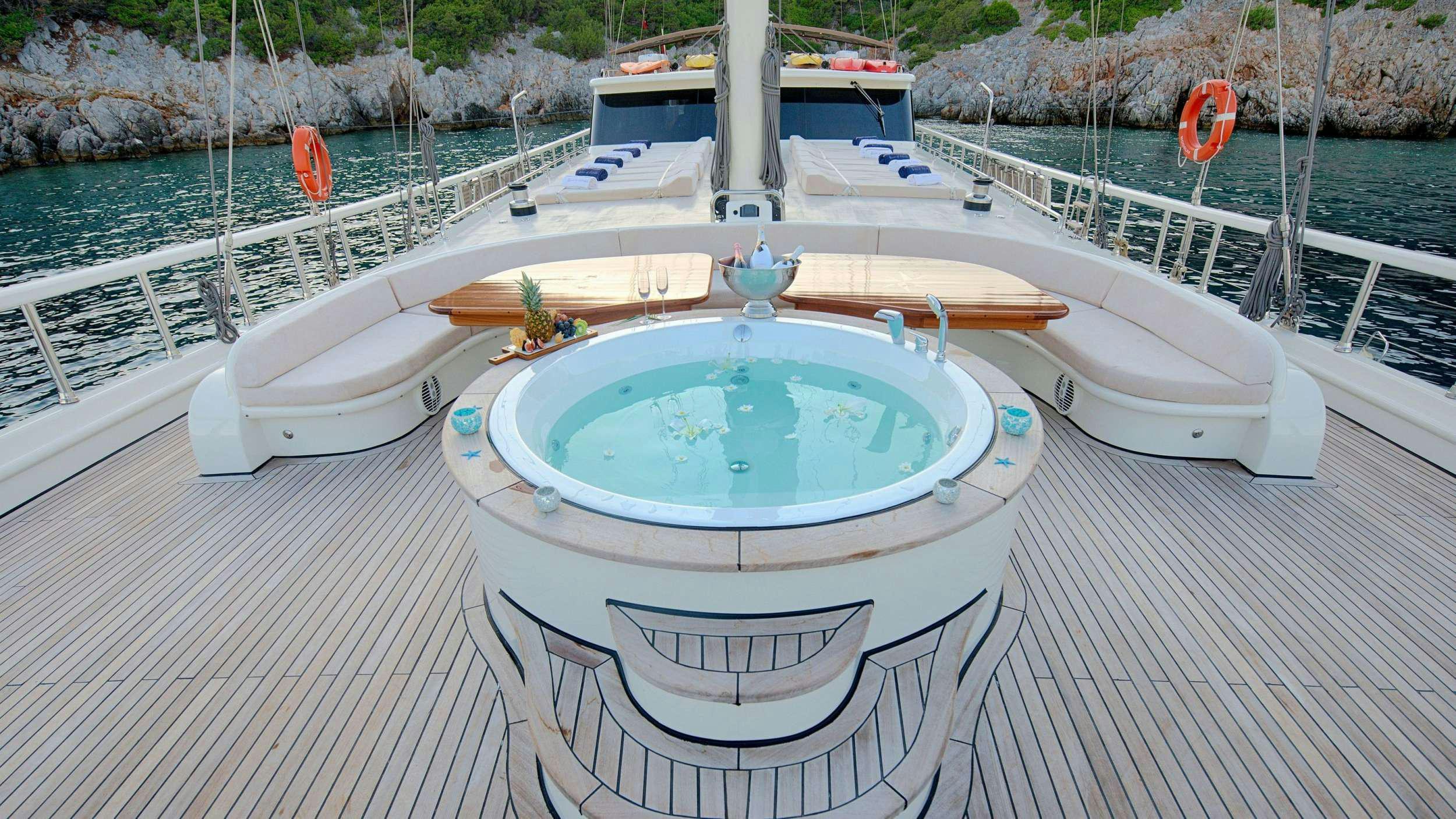 a swimming pool on a deck aboard QUEEN OF SALMAKIS Yacht for Charter