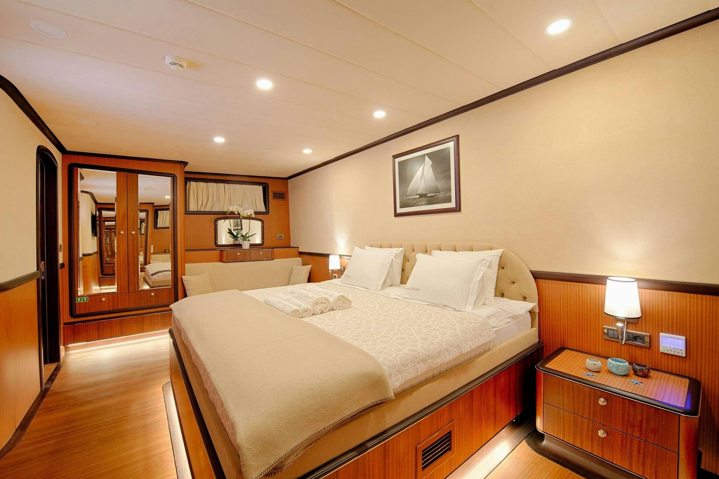a hotel room with a bed aboard QUEEN OF SALMAKIS Yacht for Charter