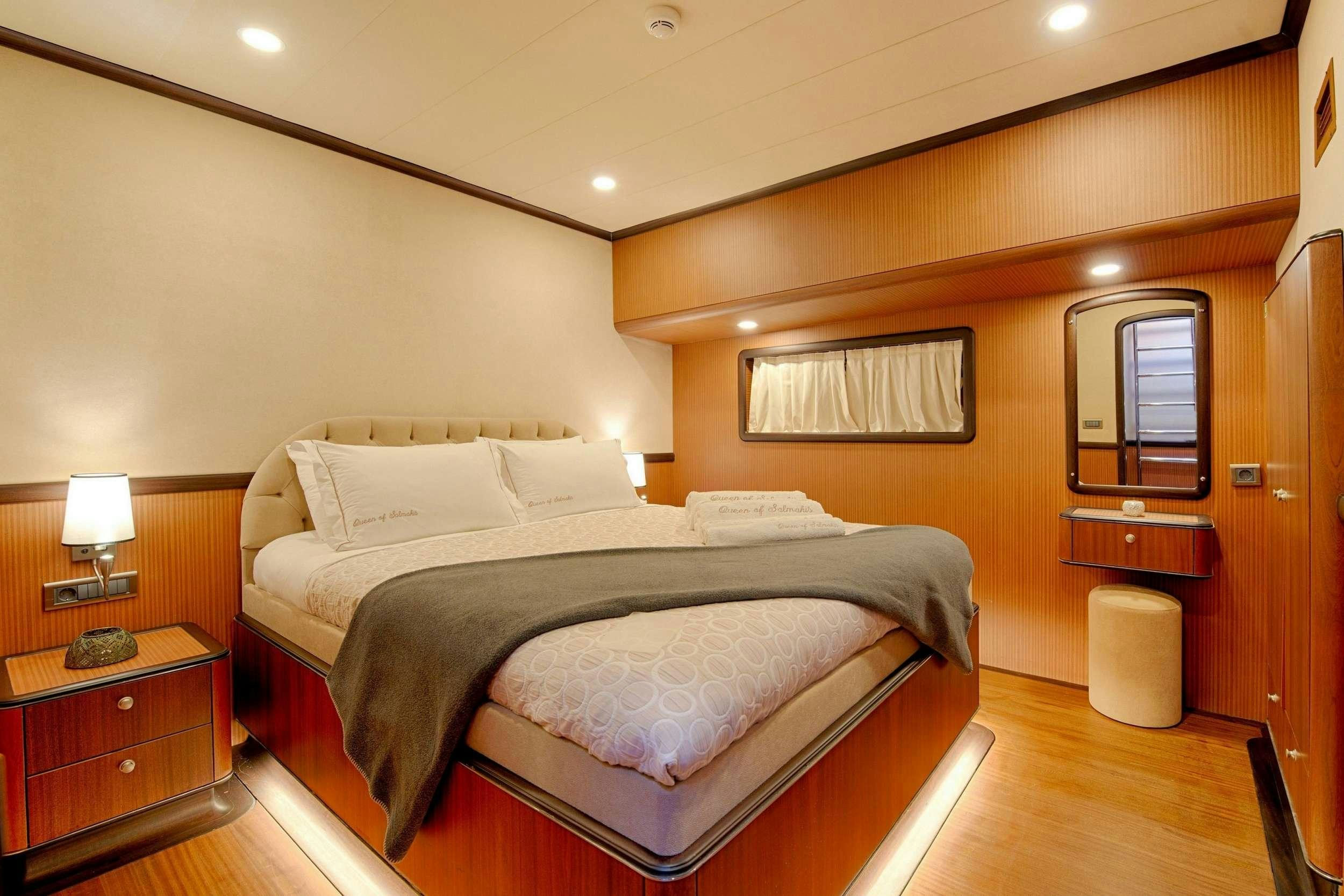 a large bed in a hotel room aboard QUEEN OF SALMAKIS Yacht for Charter