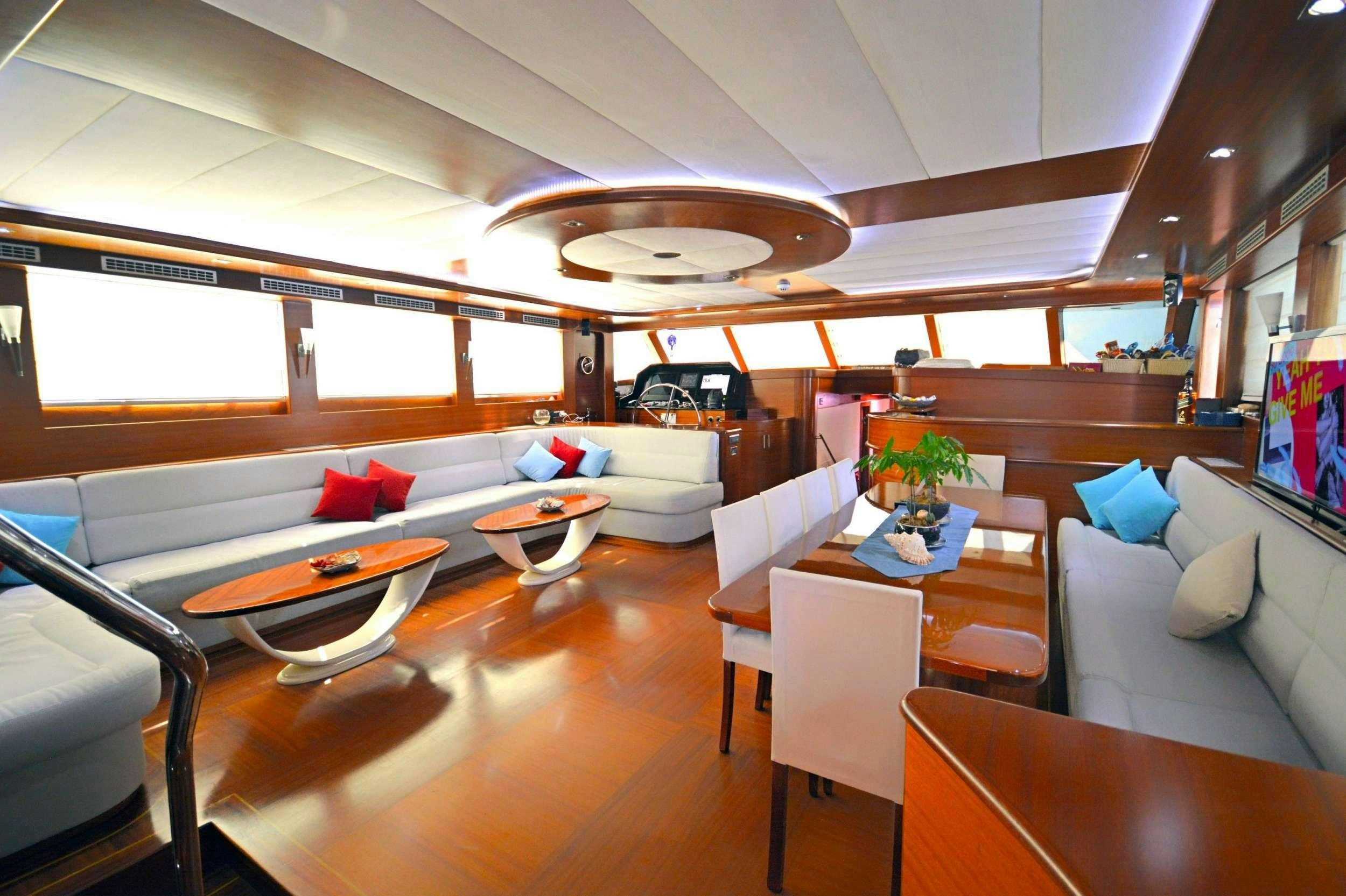 a room with a couch and a table and chairs aboard DOLCE MARE Yacht for Charter
