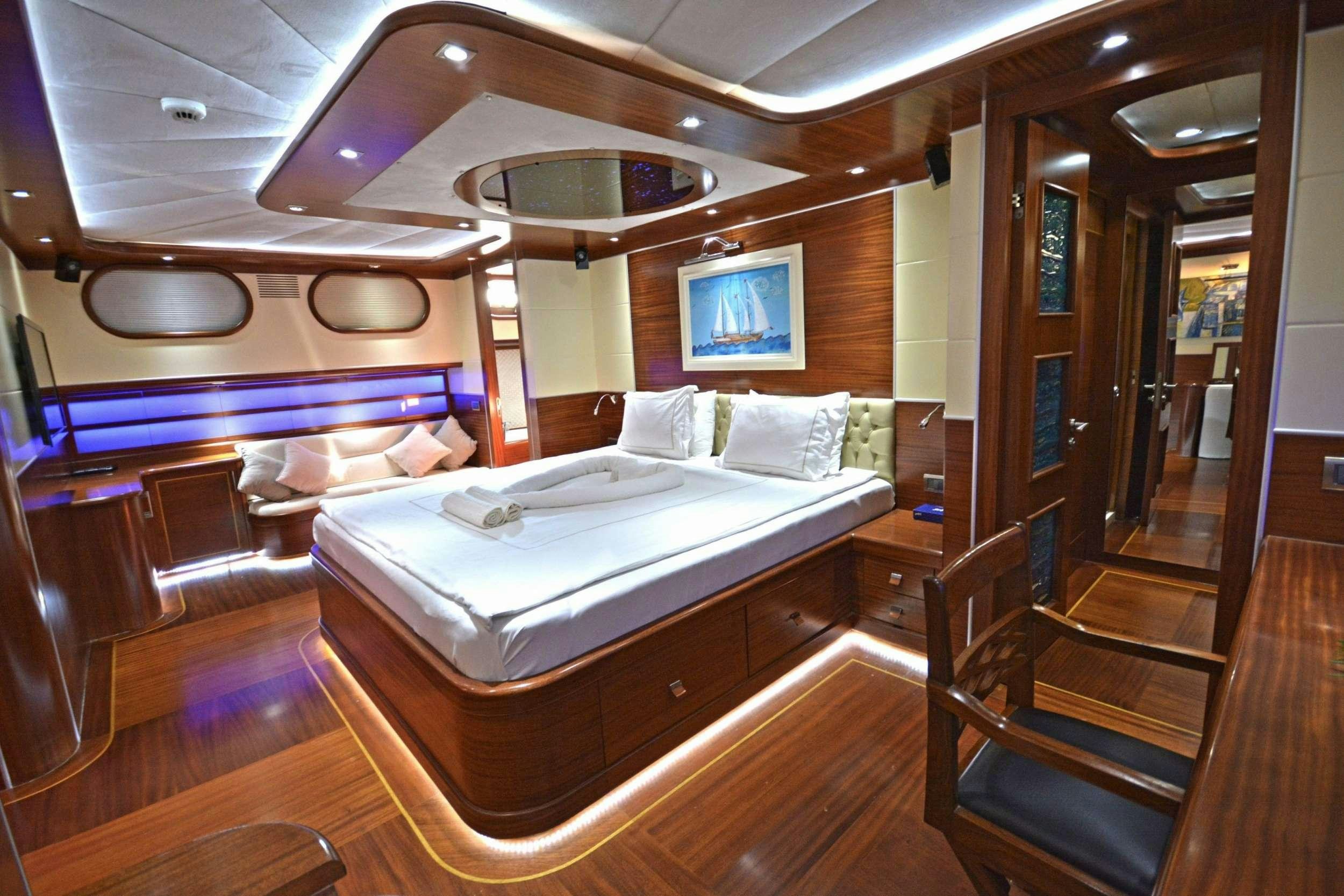a room with a bed and a mirror aboard DOLCE MARE Yacht for Charter