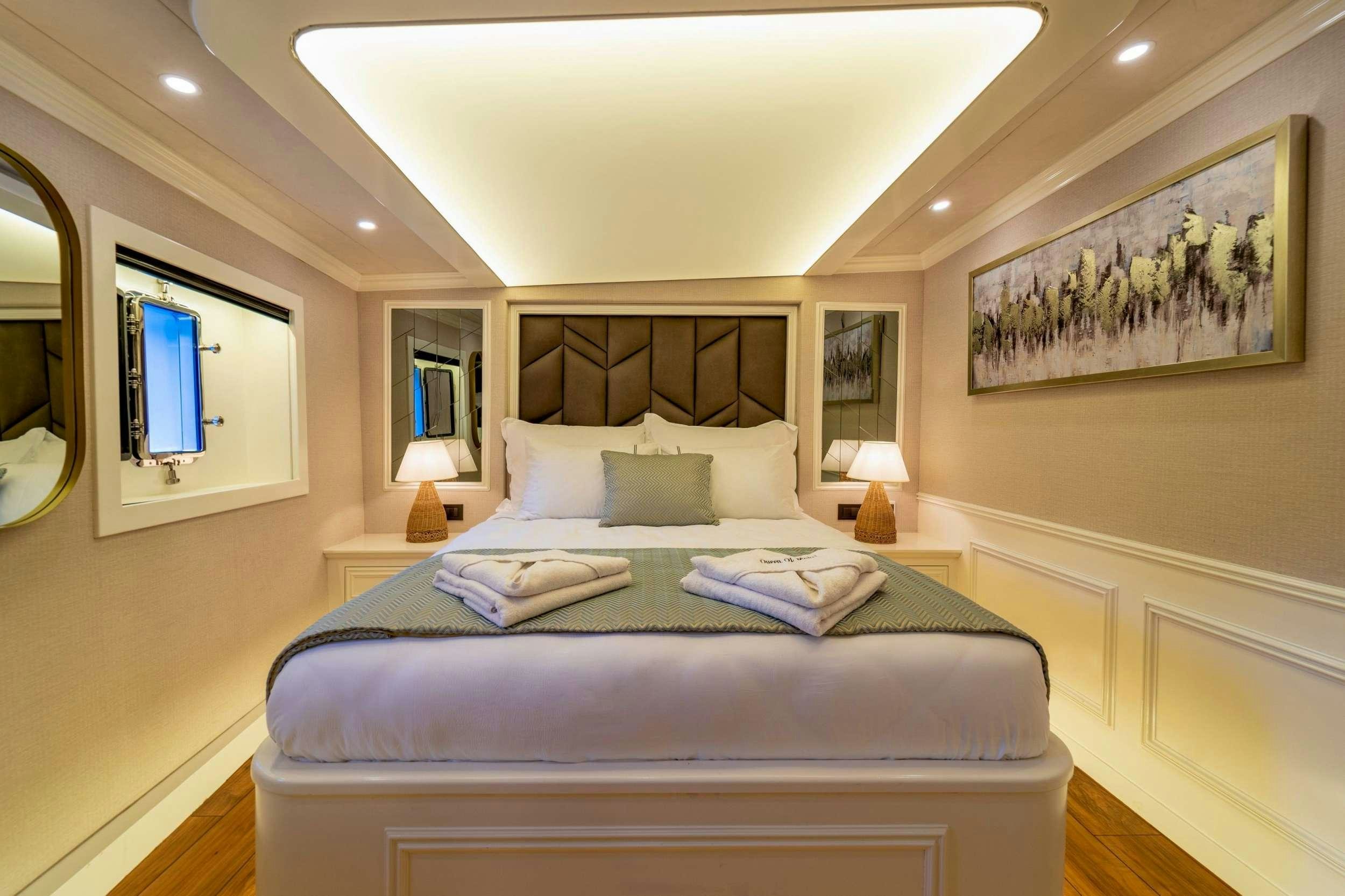 a bed with a white pillow aboard QUEEN OF MAKRI Yacht for Charter