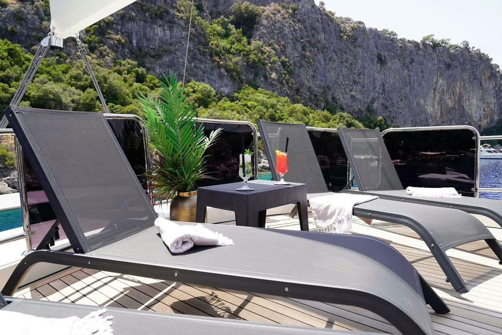 a table with laptops on it aboard QUEEN OF MAKRI Yacht for Charter