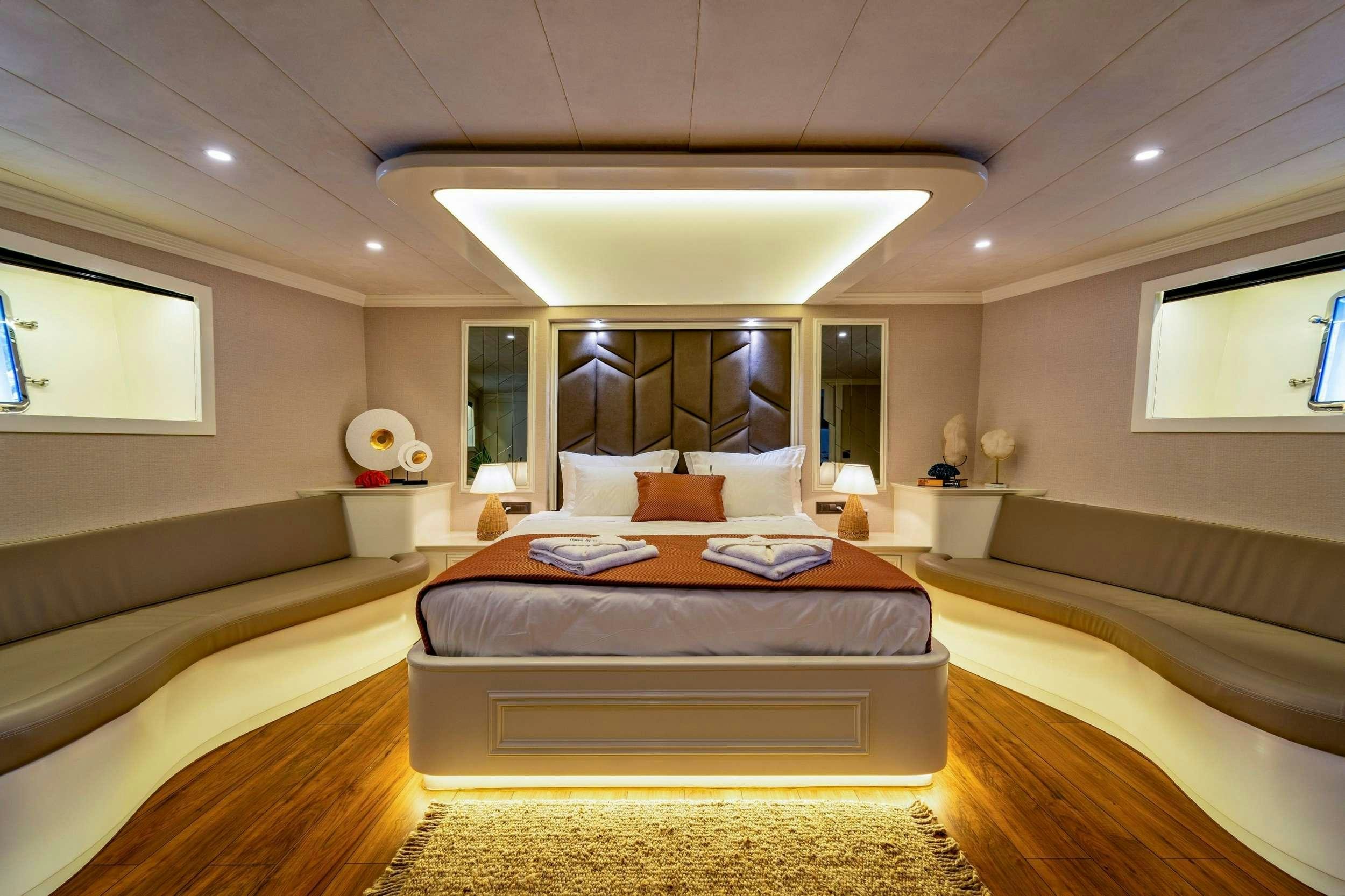 a large bedroom with a large bed aboard QUEEN OF MAKRI Yacht for Charter