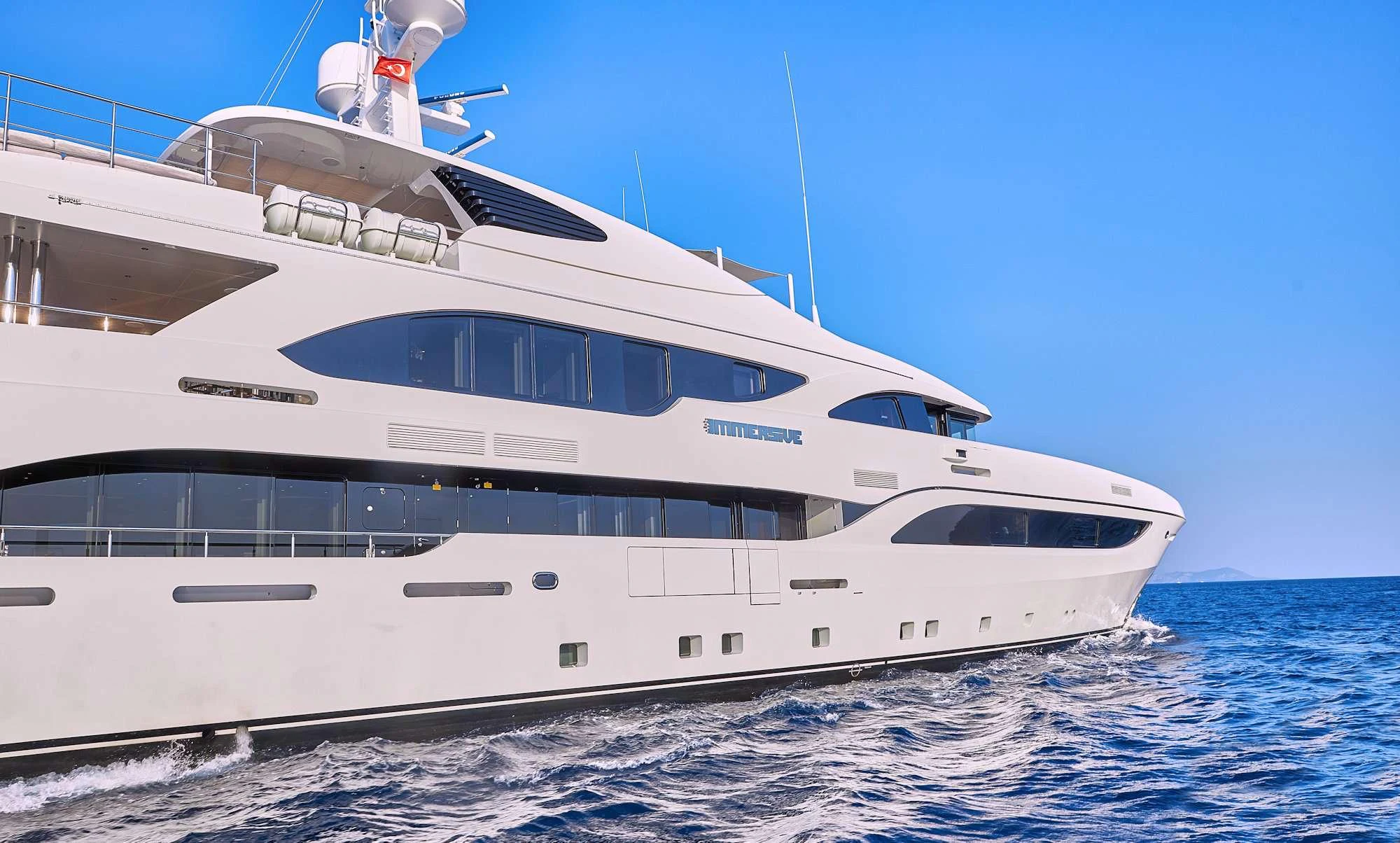 a white yacht on the water aboard IMMERSIVE Yacht for Charter