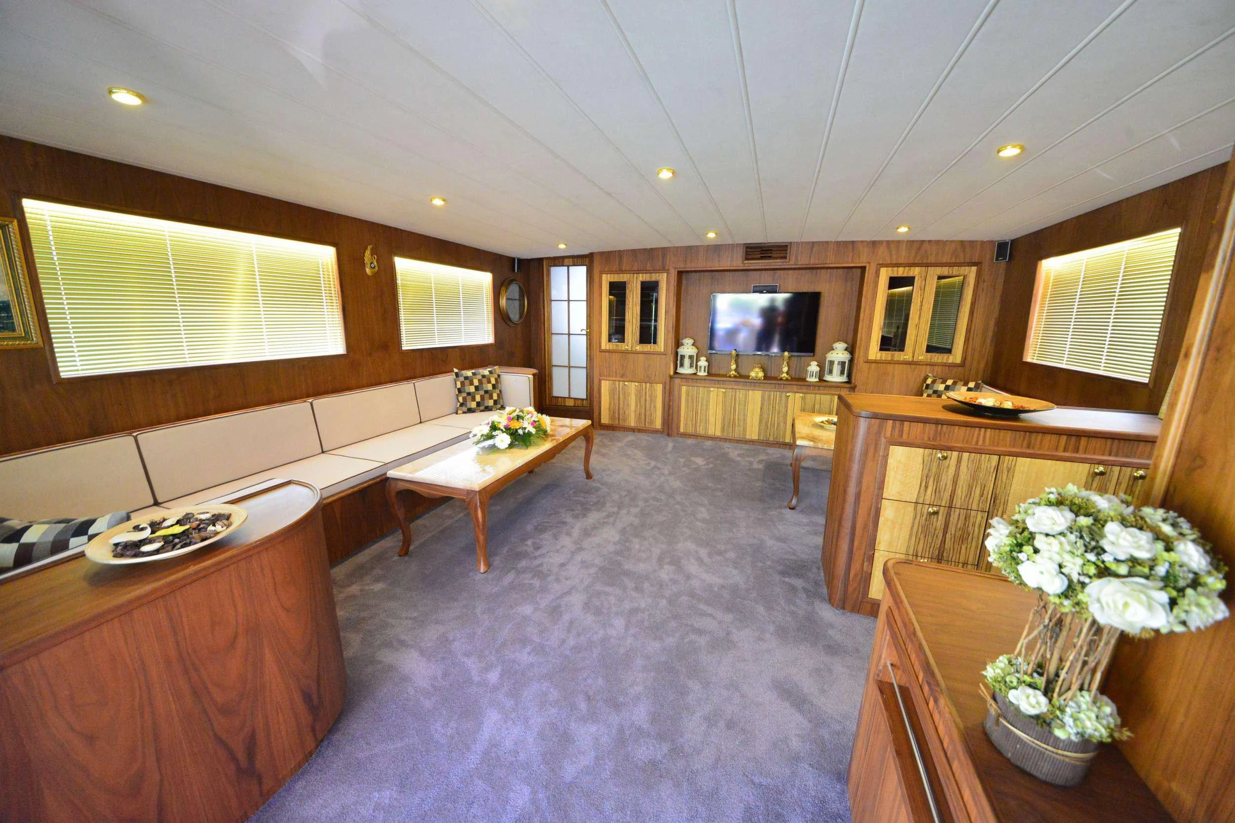 a large room with a table and chairs aboard IMMERSIVE Yacht for Charter