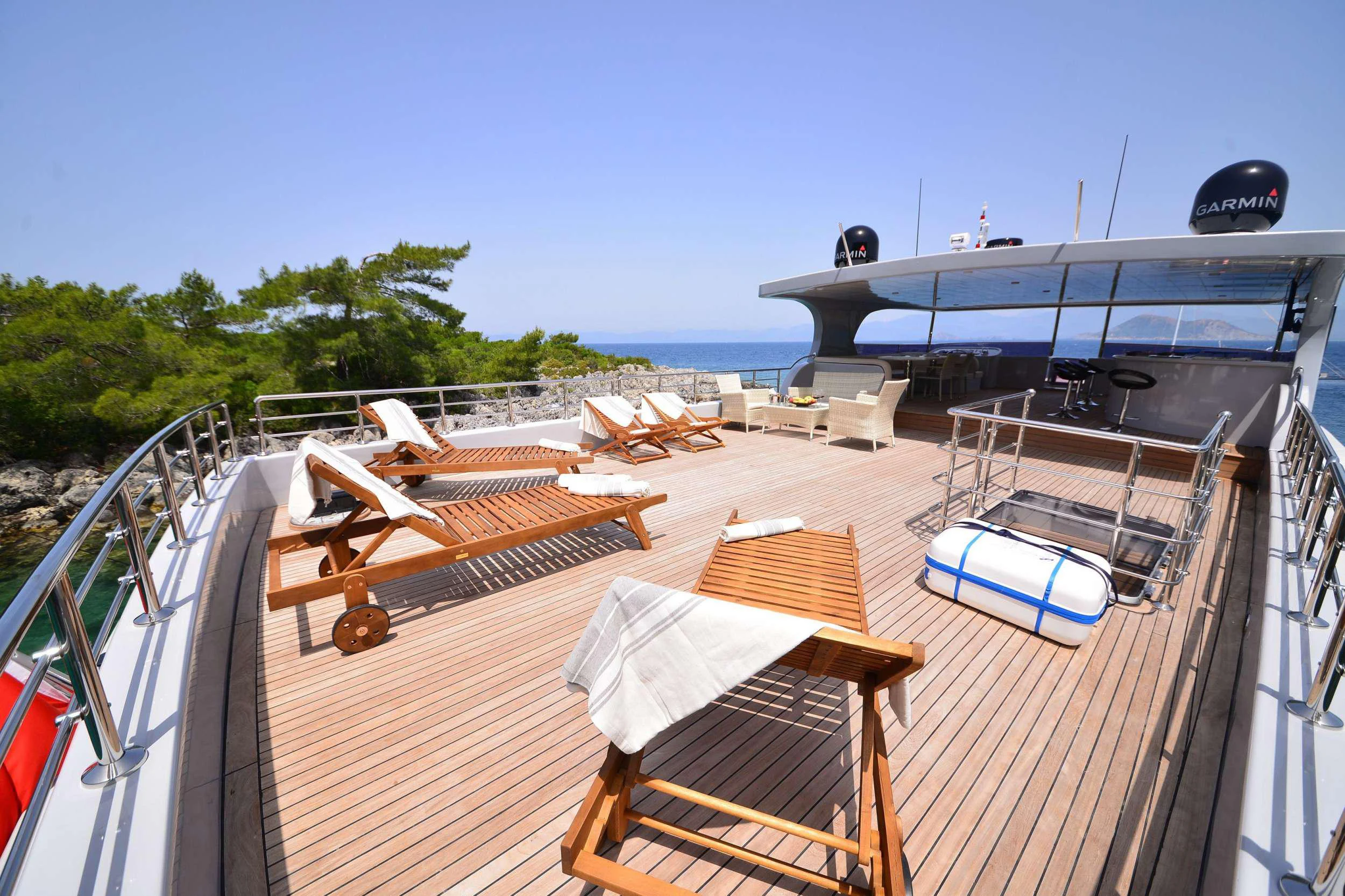 a deck with a deck and a boat on it aboard IMMERSIVE Yacht for Charter