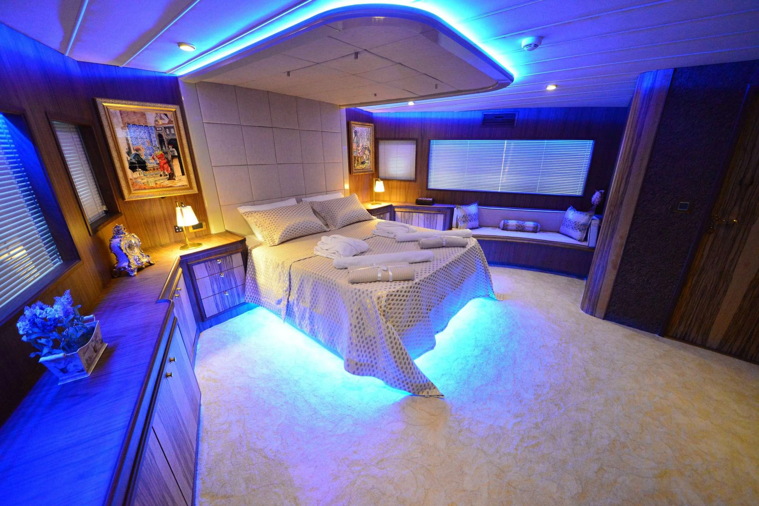 a large room with a bed and a couch aboard IMMERSIVE Yacht for Charter