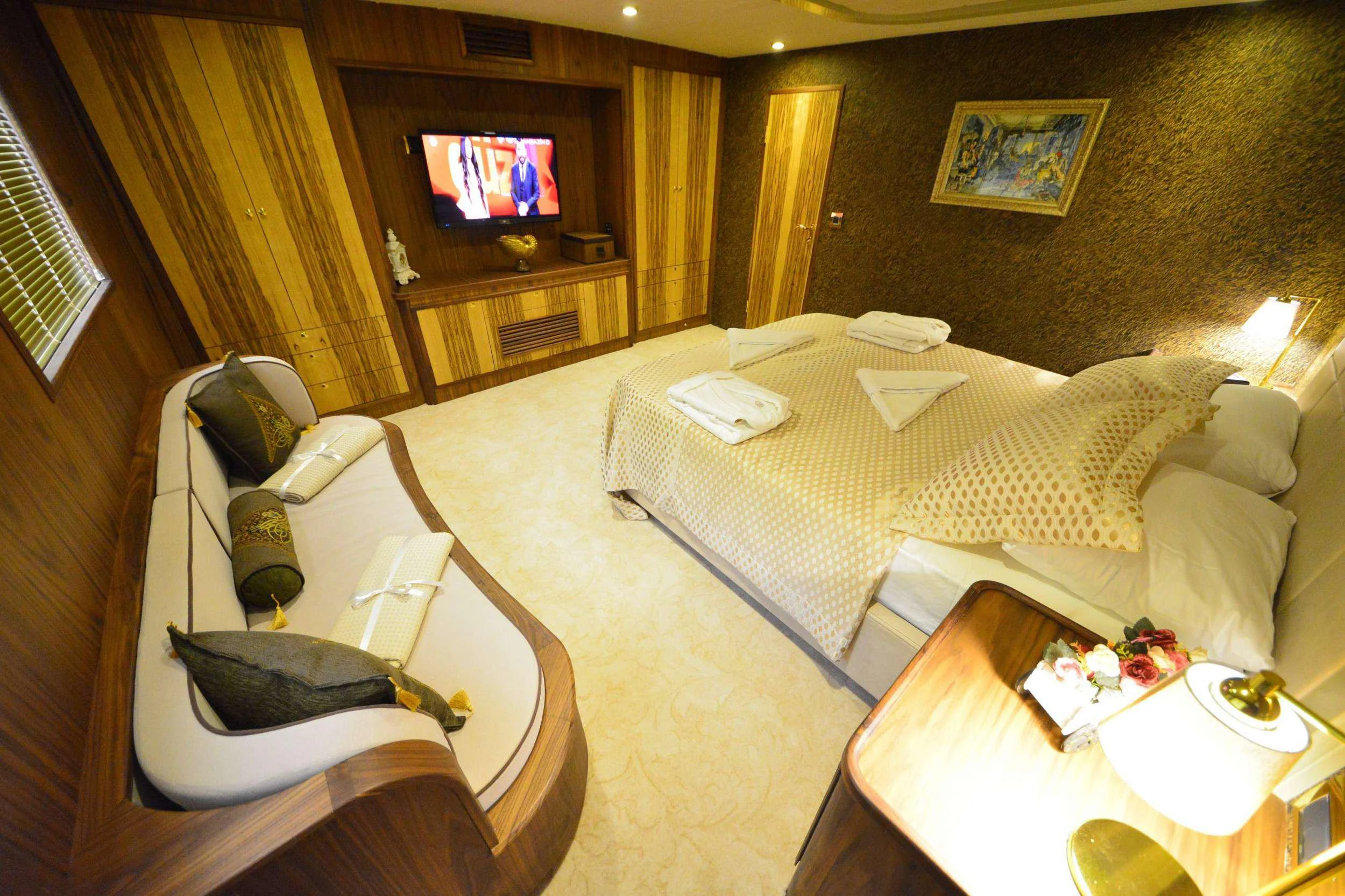 a living room with a couch and a television aboard IMMERSIVE Yacht for Charter