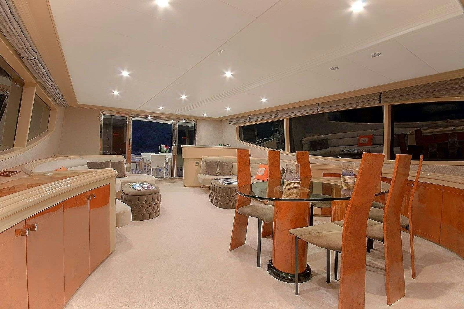 a room with tables and chairs aboard BLANCO Yacht for Charter