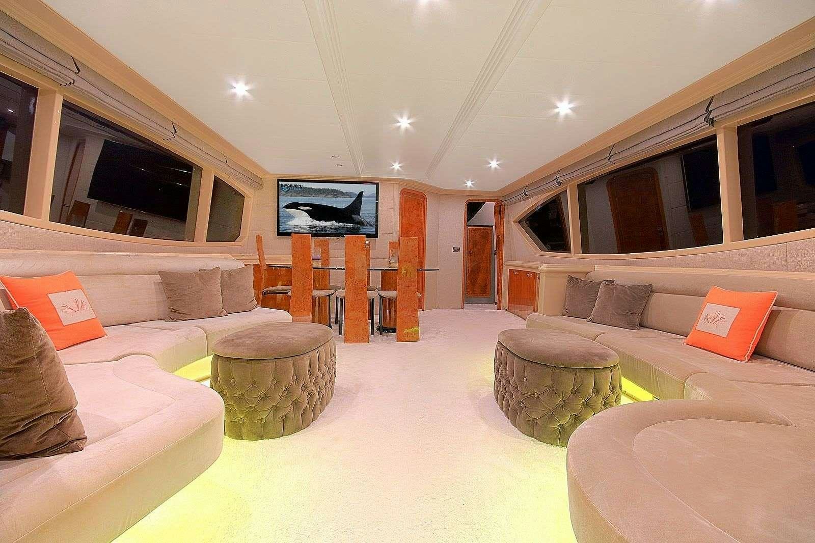 a living room with a large screen aboard BLANCO Yacht for Charter