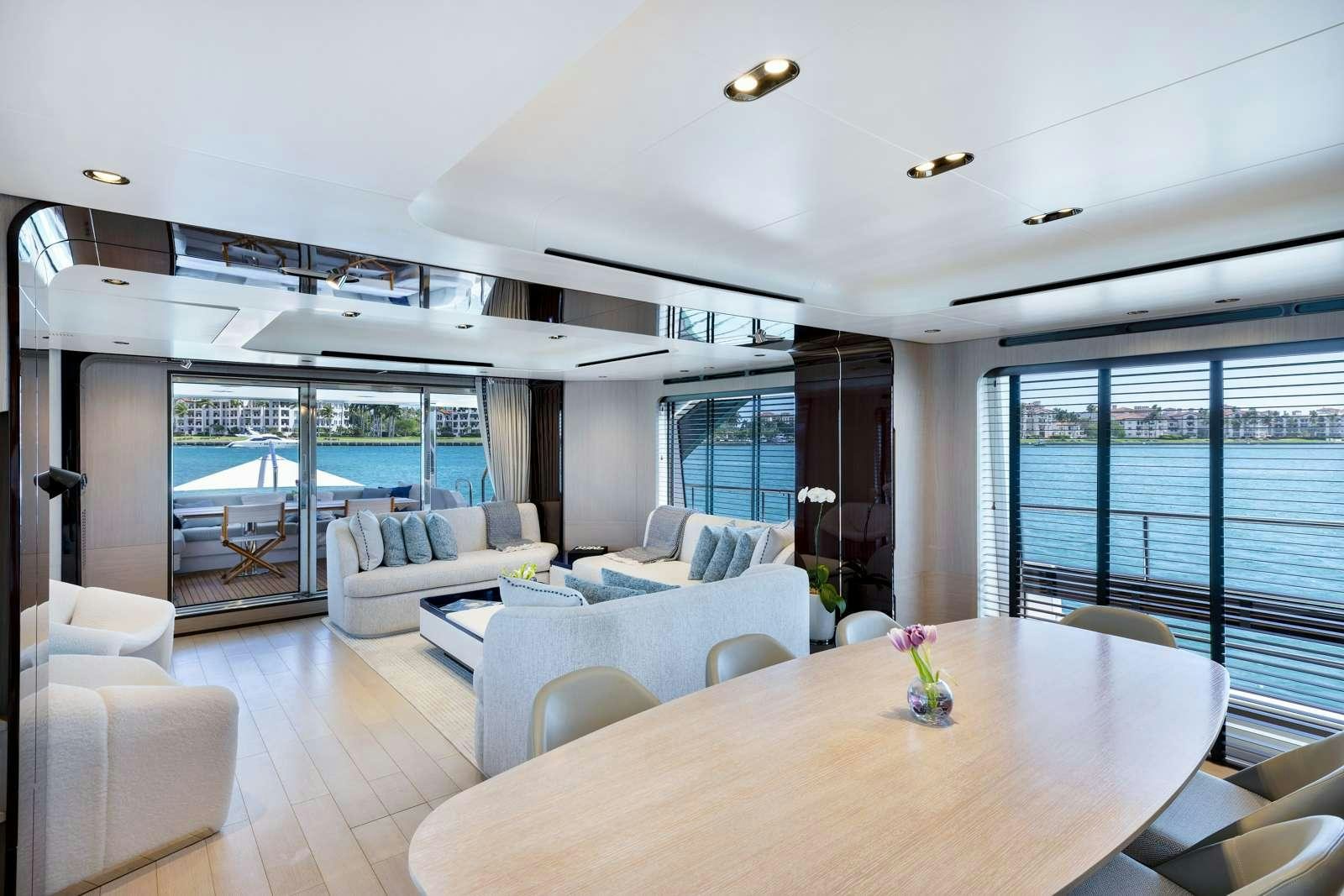 a large living room with a large glass window aboard RINA Yacht for Charter
