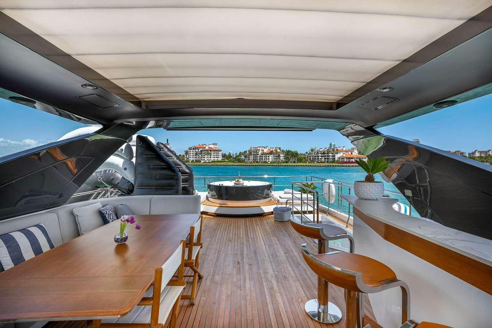a deck with a view of a city and water aboard RINA Yacht for Charter
