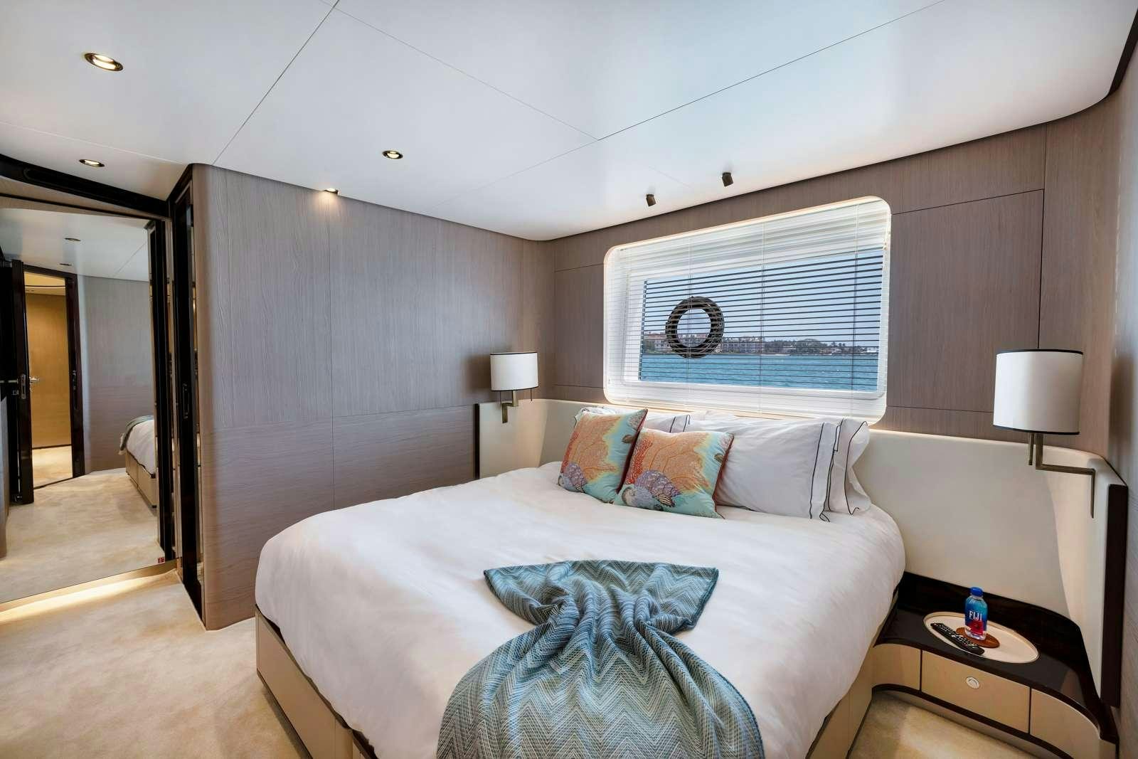 a bedroom with a bed and a lamp aboard RINA Yacht for Charter