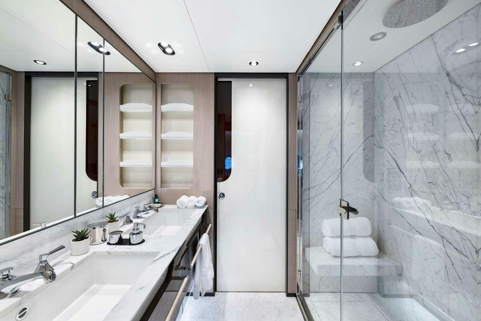 a bathroom with a glass shower aboard RINA Yacht for Charter