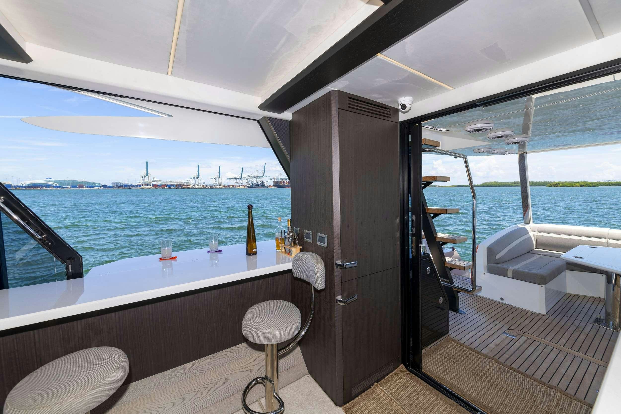 a boat with a bar and a table on the deck aboard CRYPTO LIFE Yacht for Charter