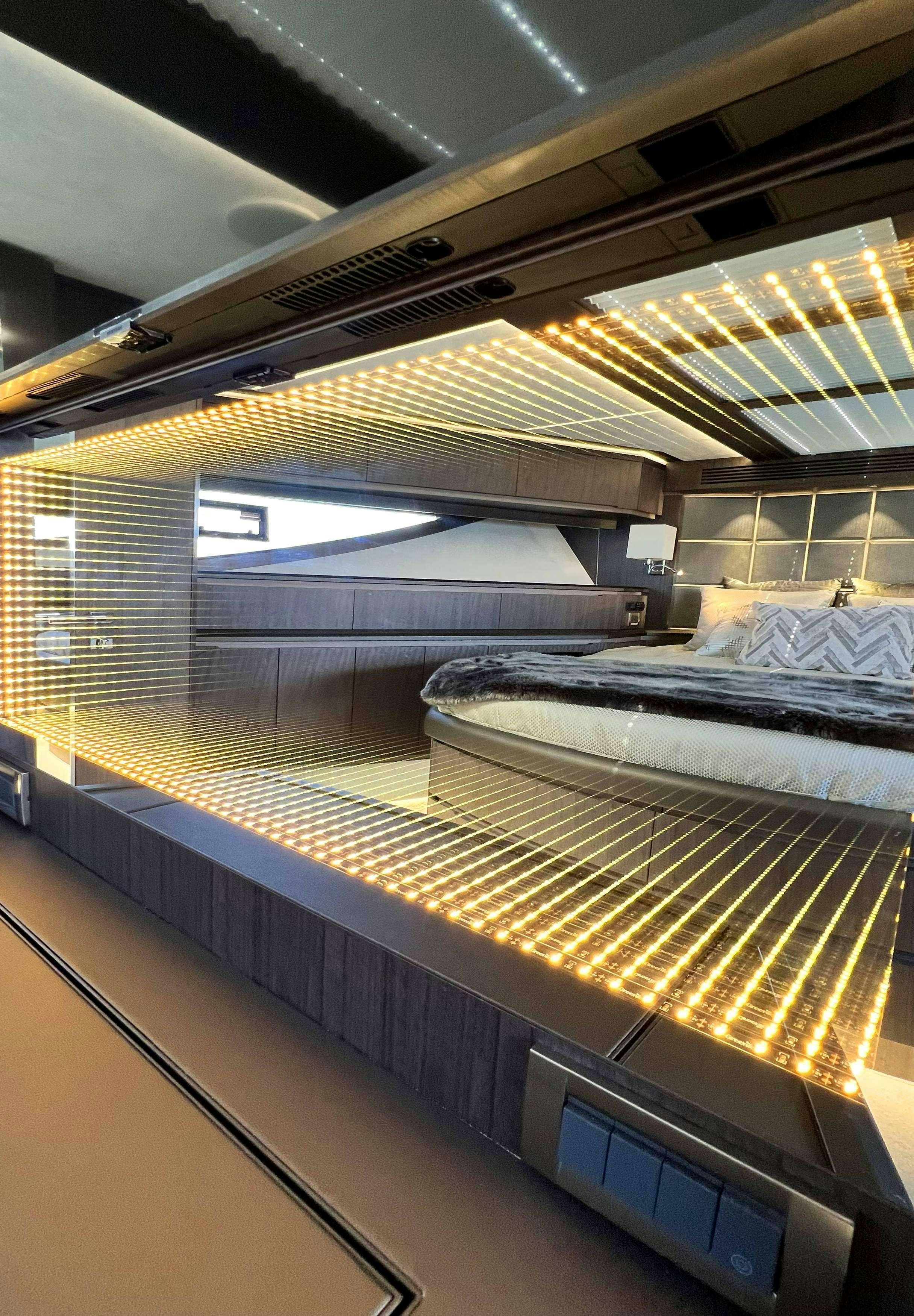 a room with a bed and a large window aboard CRYPTO LIFE Yacht for Charter