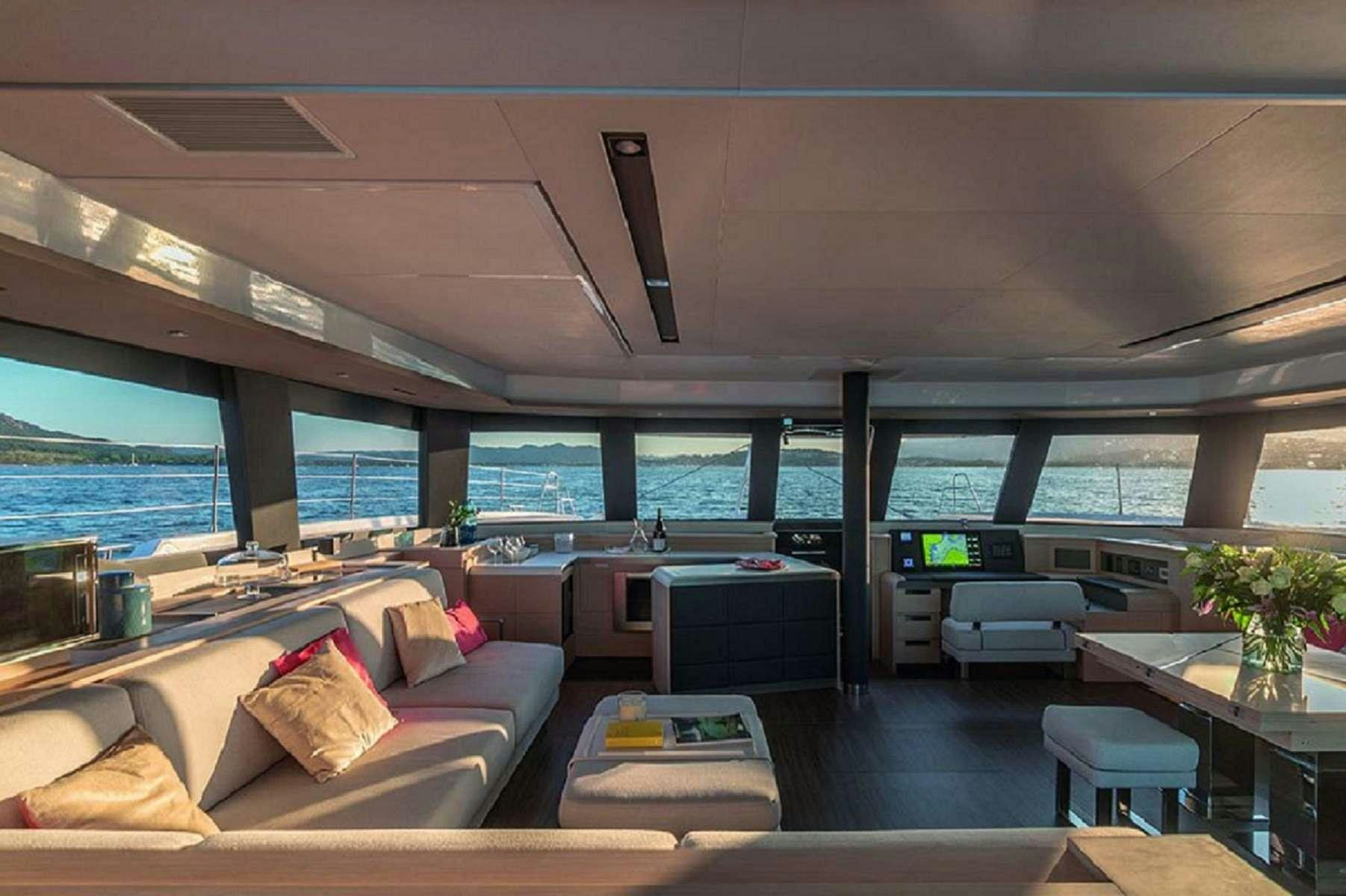 a living room with a large window aboard OCEANUS Yacht for Charter