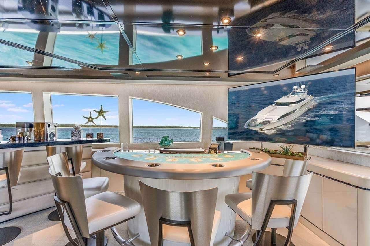 a room with tables and chairs aboard CUPCAKE Yacht for Charter