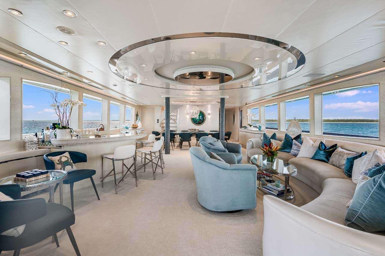 a living room with a large chandelier aboard CUPCAKE Yacht for Charter