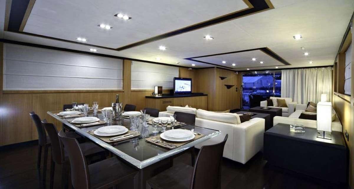 a large room with a table and chairs aboard BLUE HEAVEN 2 Yacht for Charter