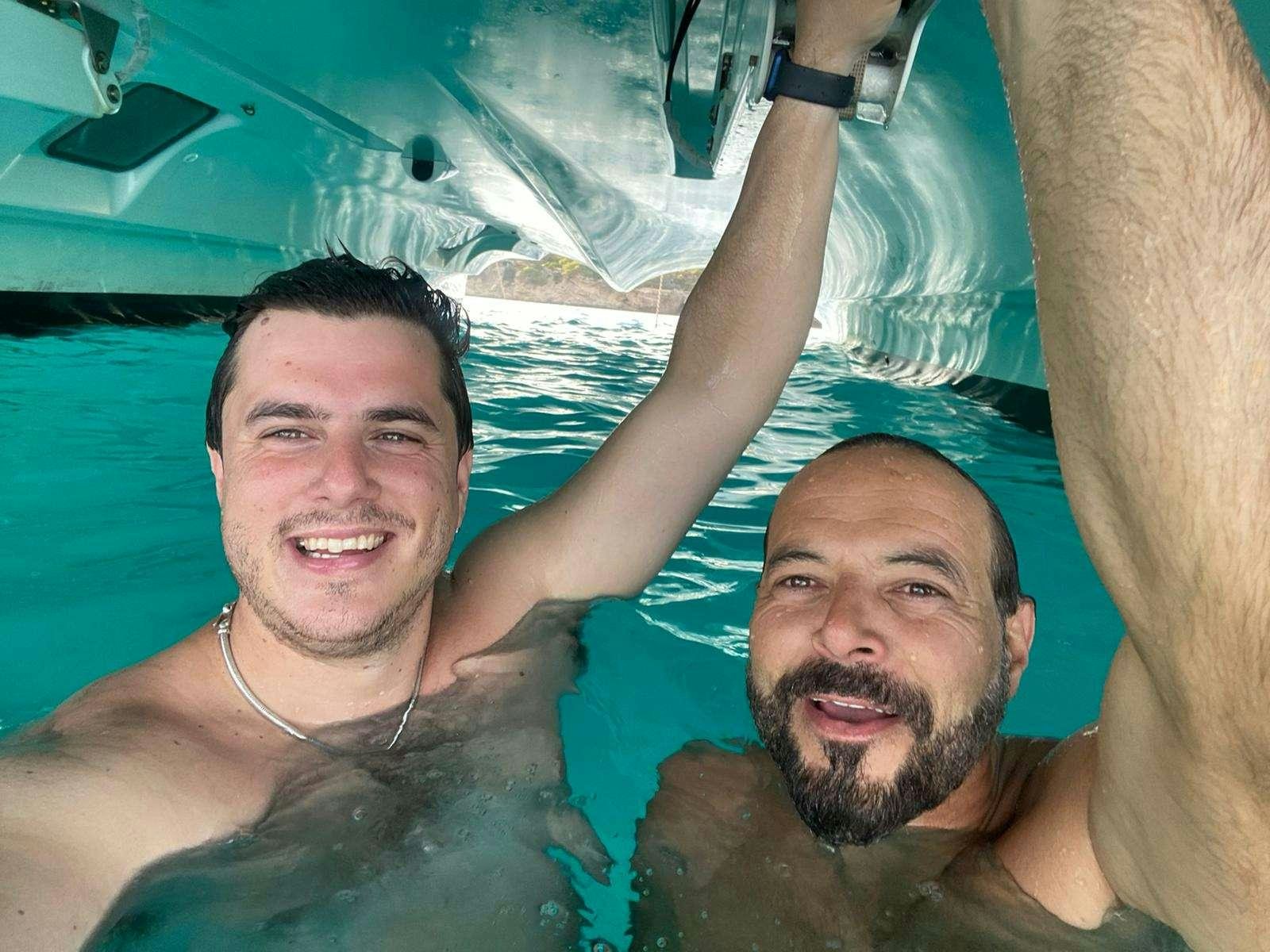 two men in a swimming pool aboard ISLAS CHAFARINAS  Yacht for Charter