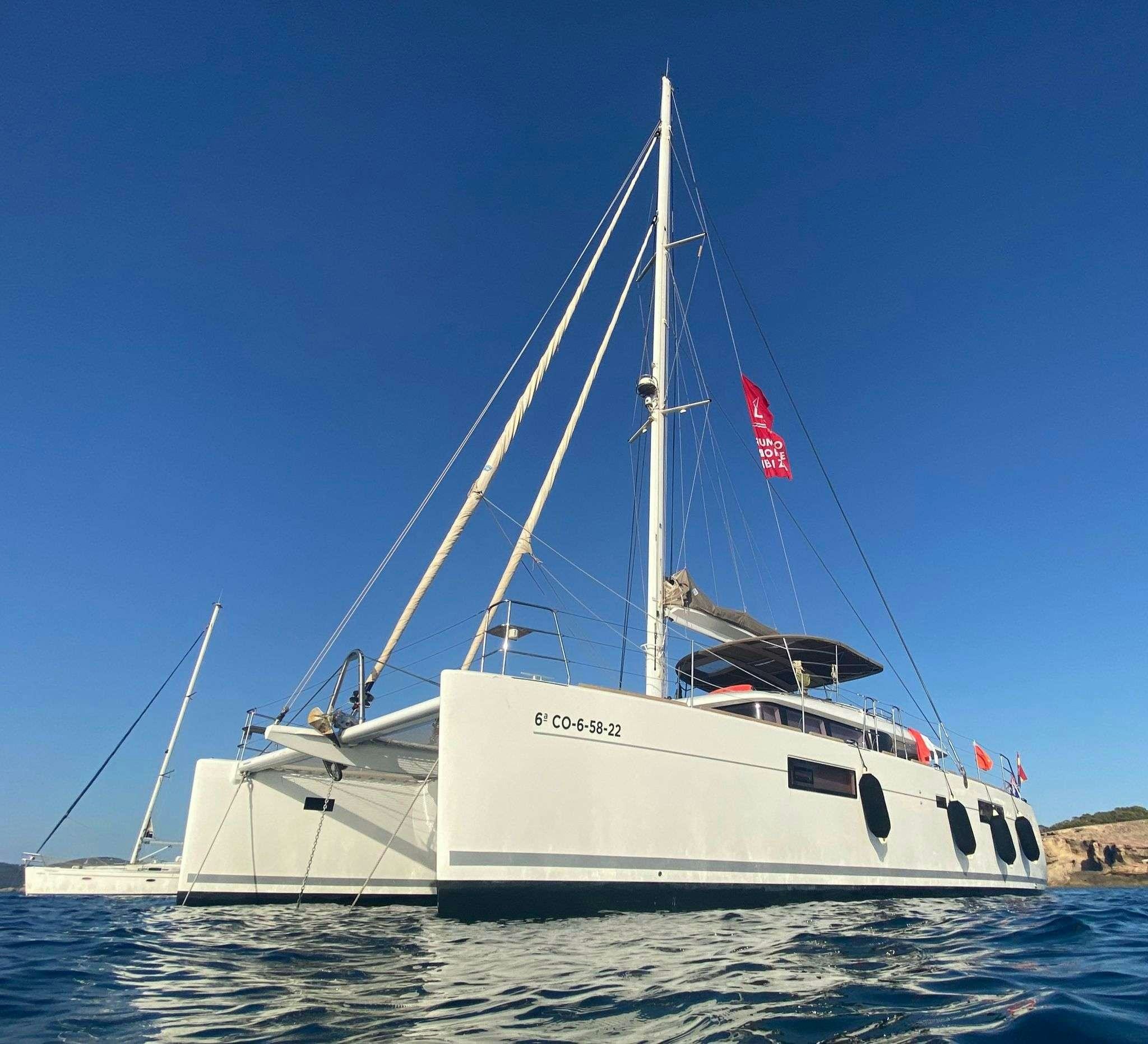 a white boat in the water aboard ISLAS CHAFARINAS  Yacht for Charter
