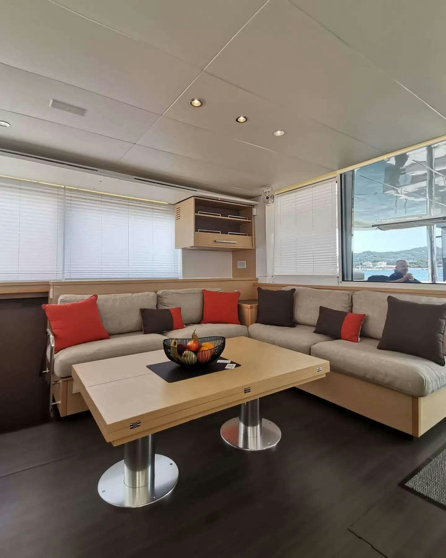a living room with a couch and a coffee table aboard ISLAS CHAFARINAS  Yacht for Charter
