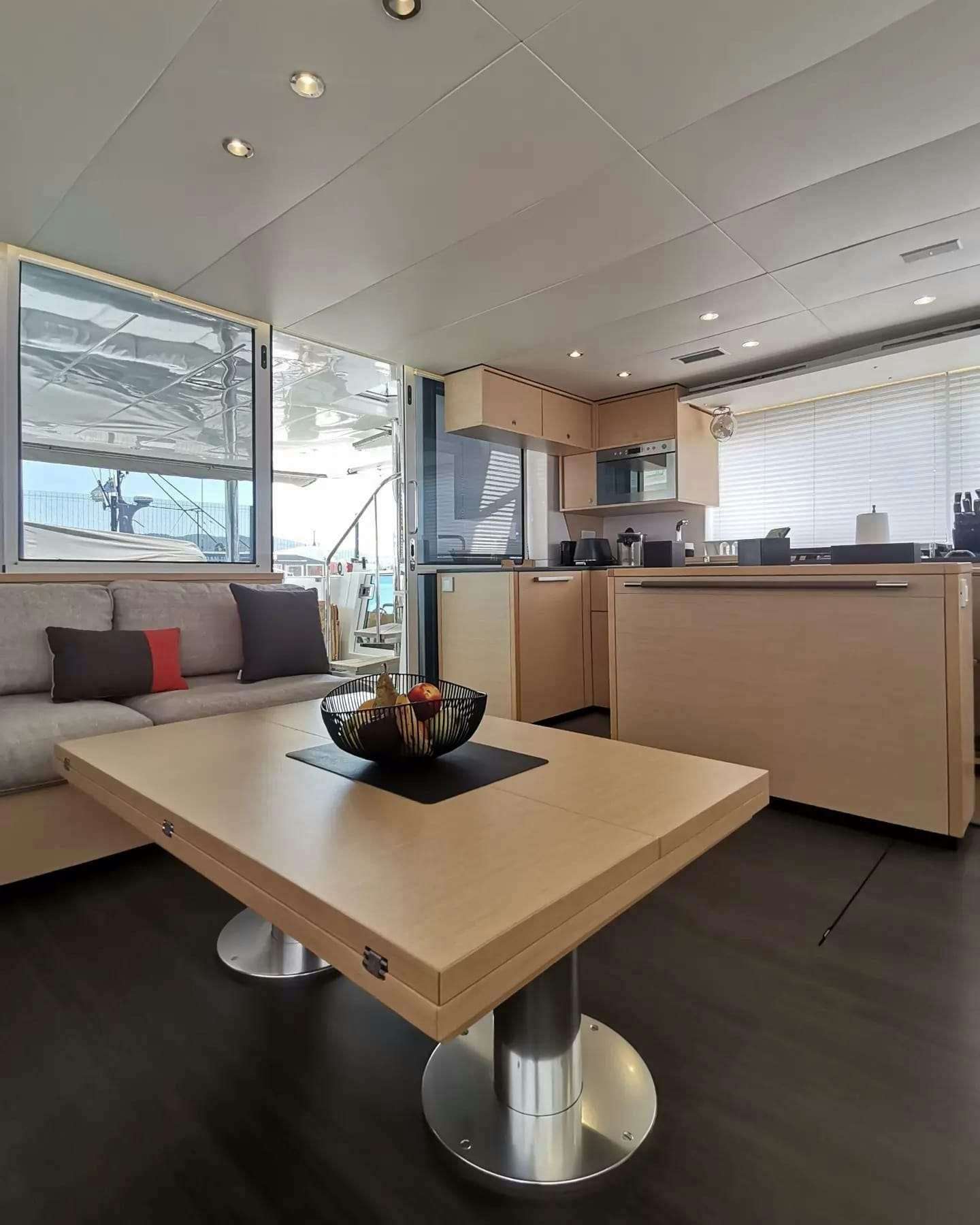 a kitchen with a table and a couch aboard ISLAS CHAFARINAS  Yacht for Charter