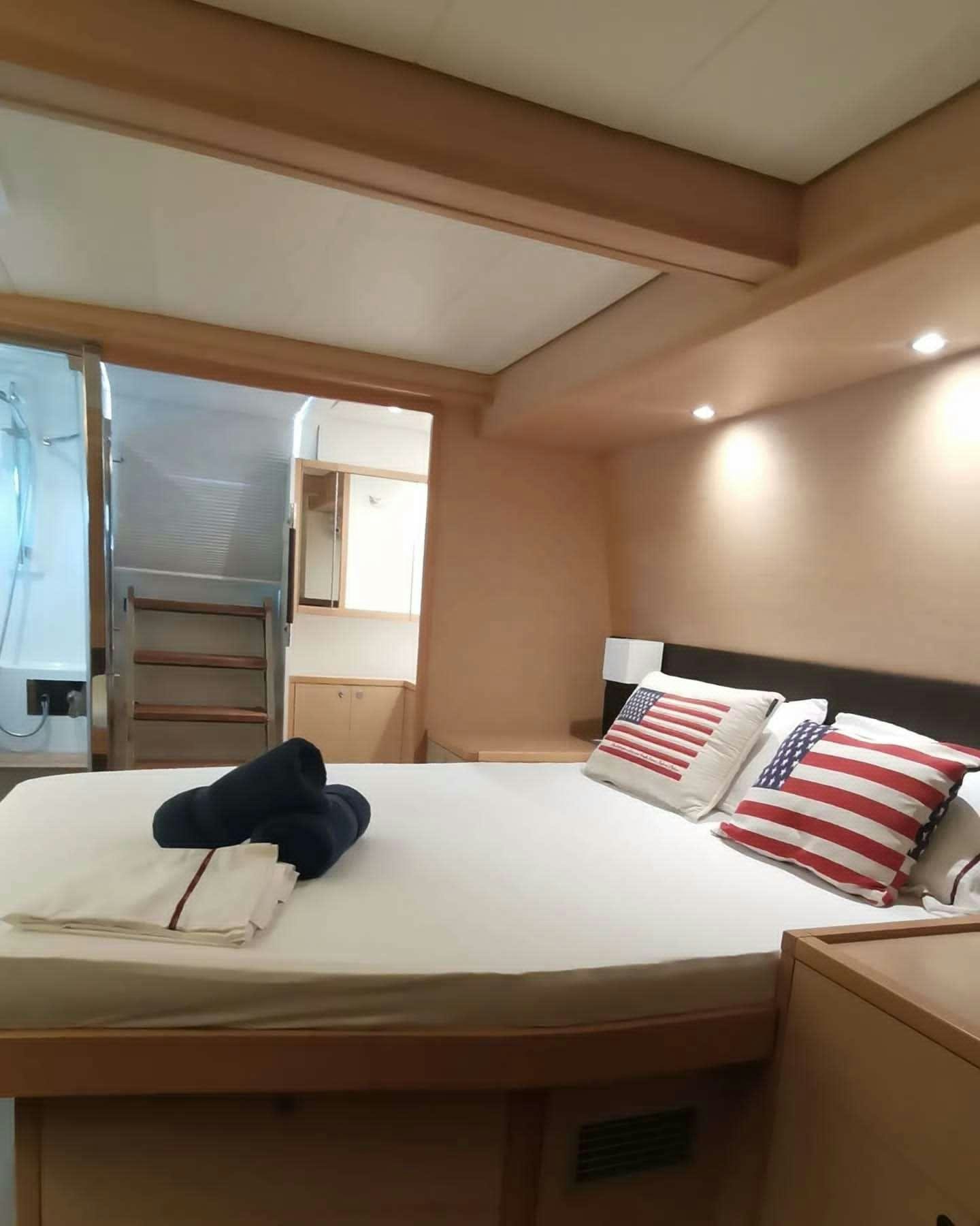 a bed with pillows and pillows aboard ISLAS CHAFARINAS  Yacht for Charter