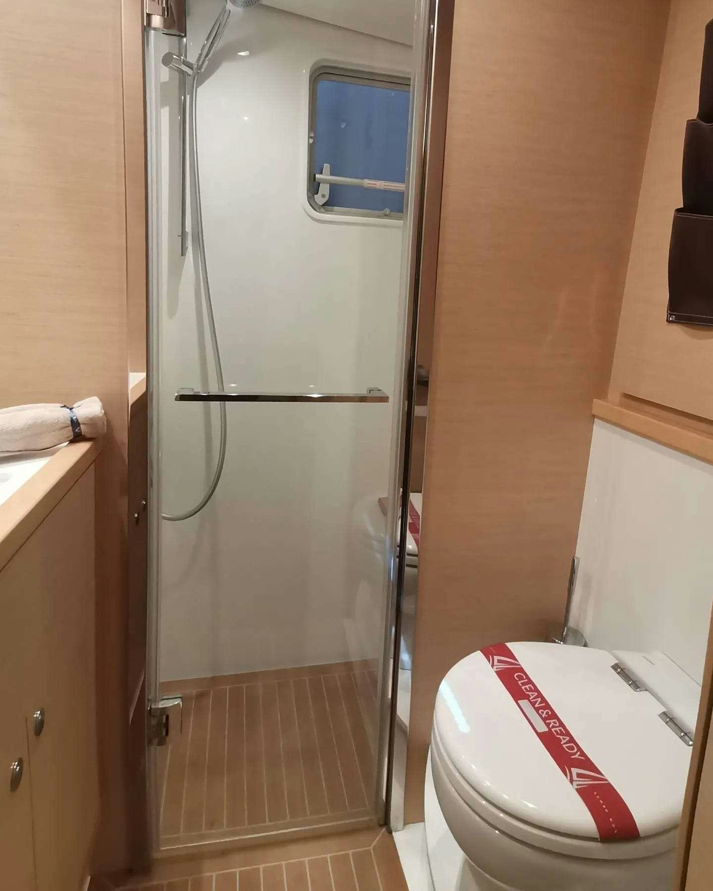 a shower unit with a red and white seat aboard ISLAS CHAFARINAS  Yacht for Charter