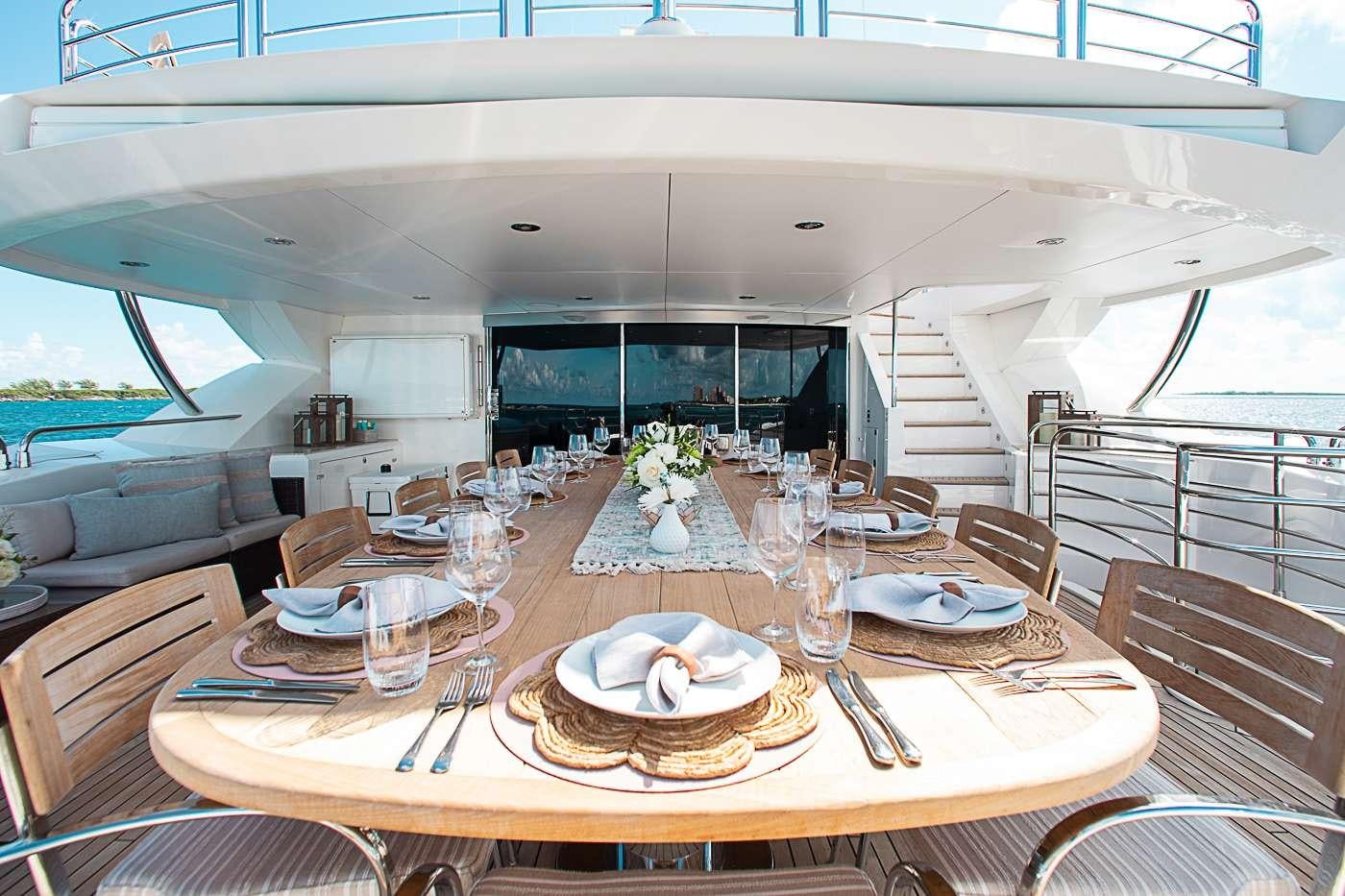 a dining table with plates and silverware on it aboard ACACIA Yacht for Charter