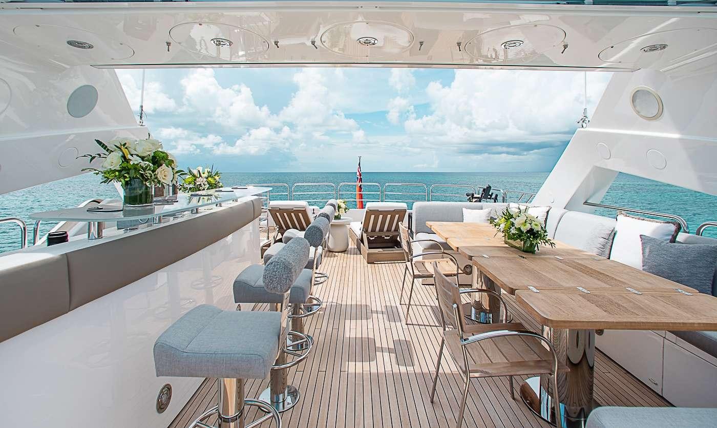 a room with tables and chairs aboard ACACIA Yacht for Charter