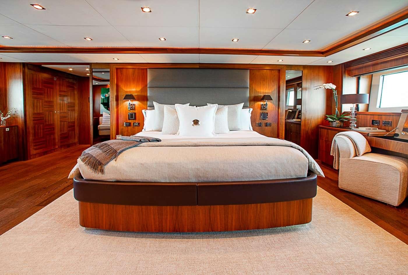 a large bed in a hotel room aboard ACACIA Yacht for Charter