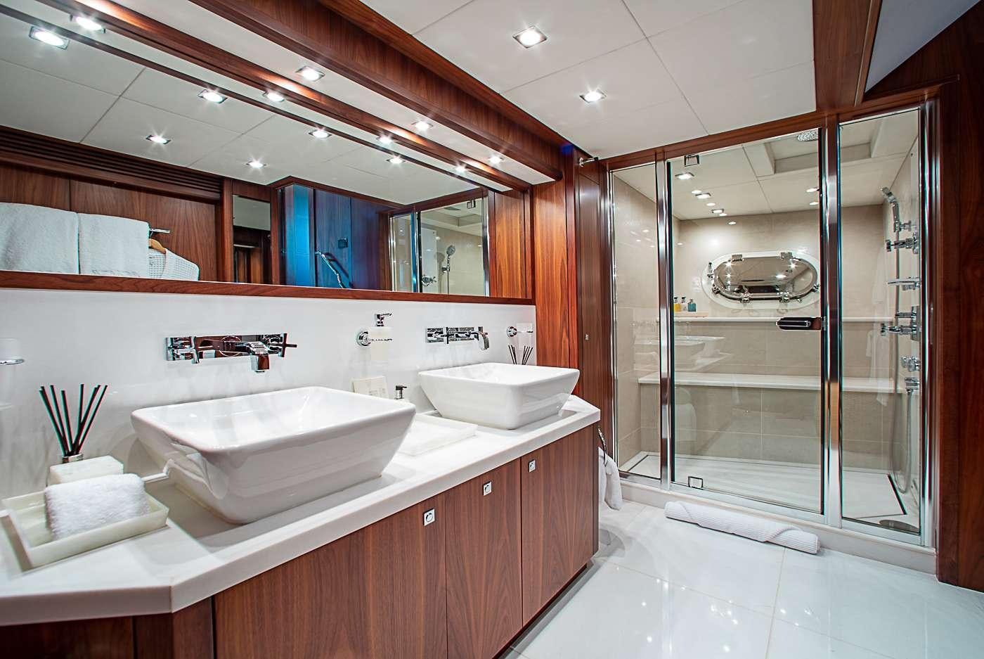 a bathroom with a large mirror aboard ACACIA Yacht for Charter