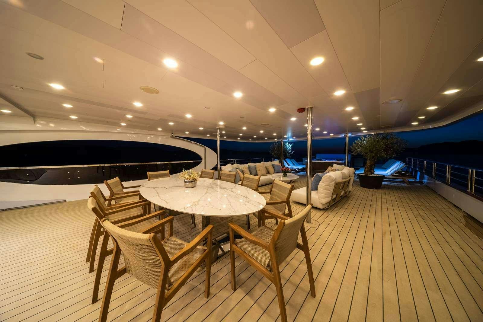 a room with a table and chairs aboard OLIMP Yacht for Charter
