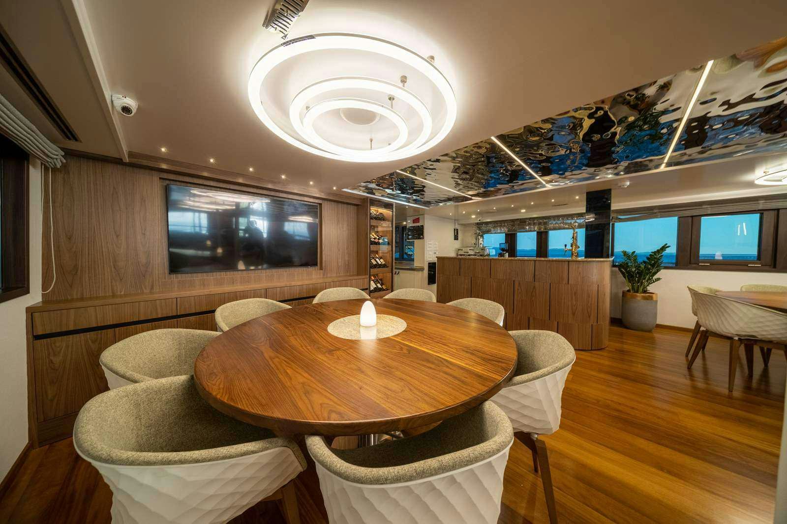 a room with a table and chairs aboard OLIMP Yacht for Charter