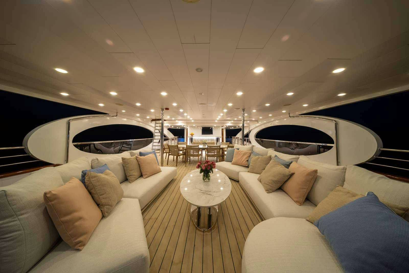 a living room with a large fireplace aboard OLIMP Yacht for Charter
