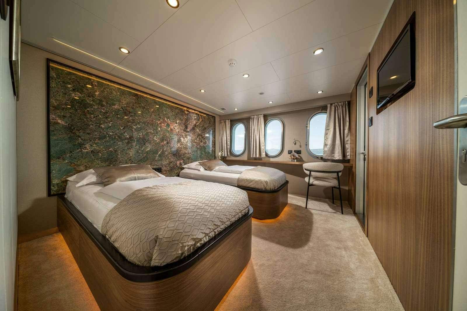 a bedroom with a large bed aboard OLIMP Yacht for Charter