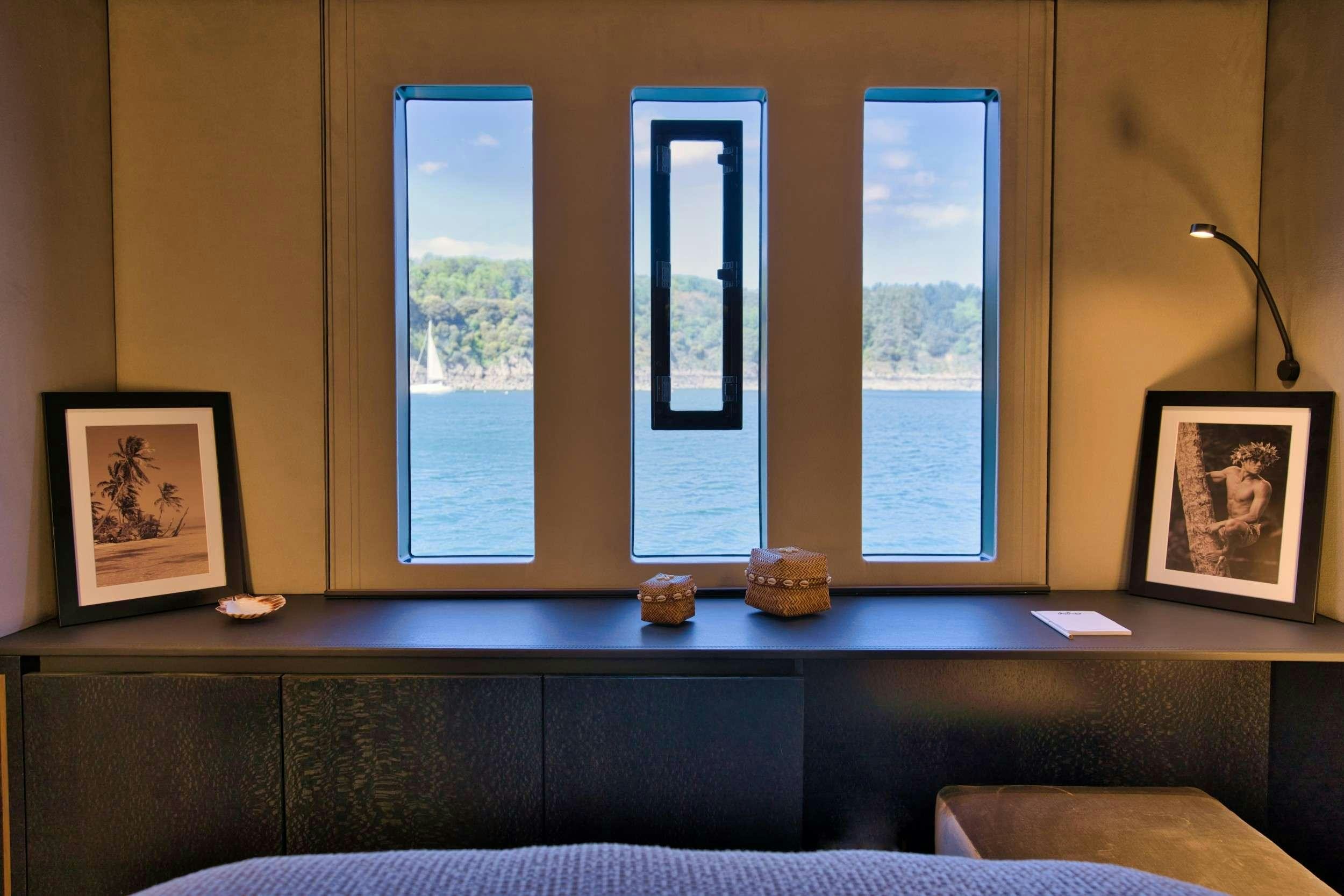 a room with a couch and a window aboard GINETTE Yacht for Charter