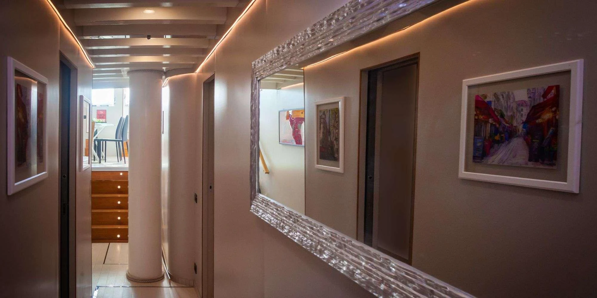 A stylish hallway with modern decor and ambient lighting. aboard LA MER Yacht for Charter