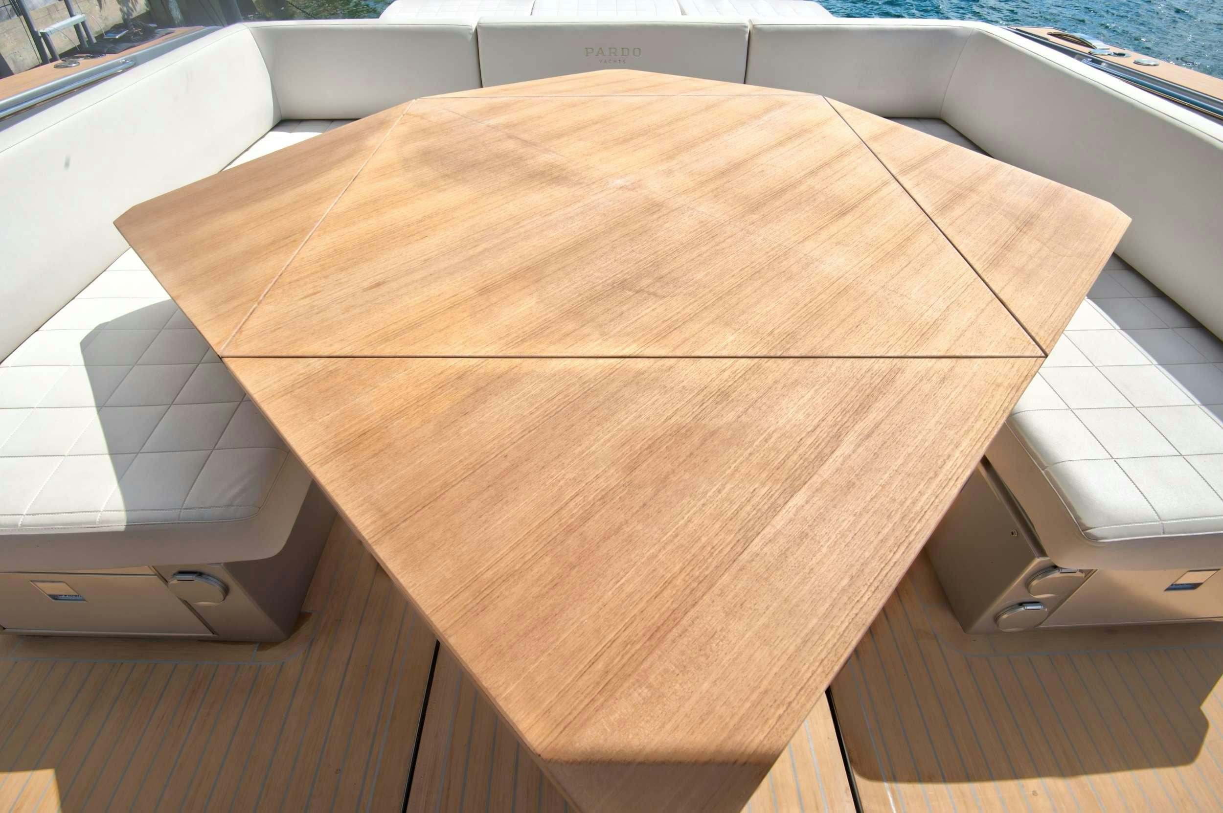a wooden table with a box on top aboard PARDO 50 Yacht for Charter